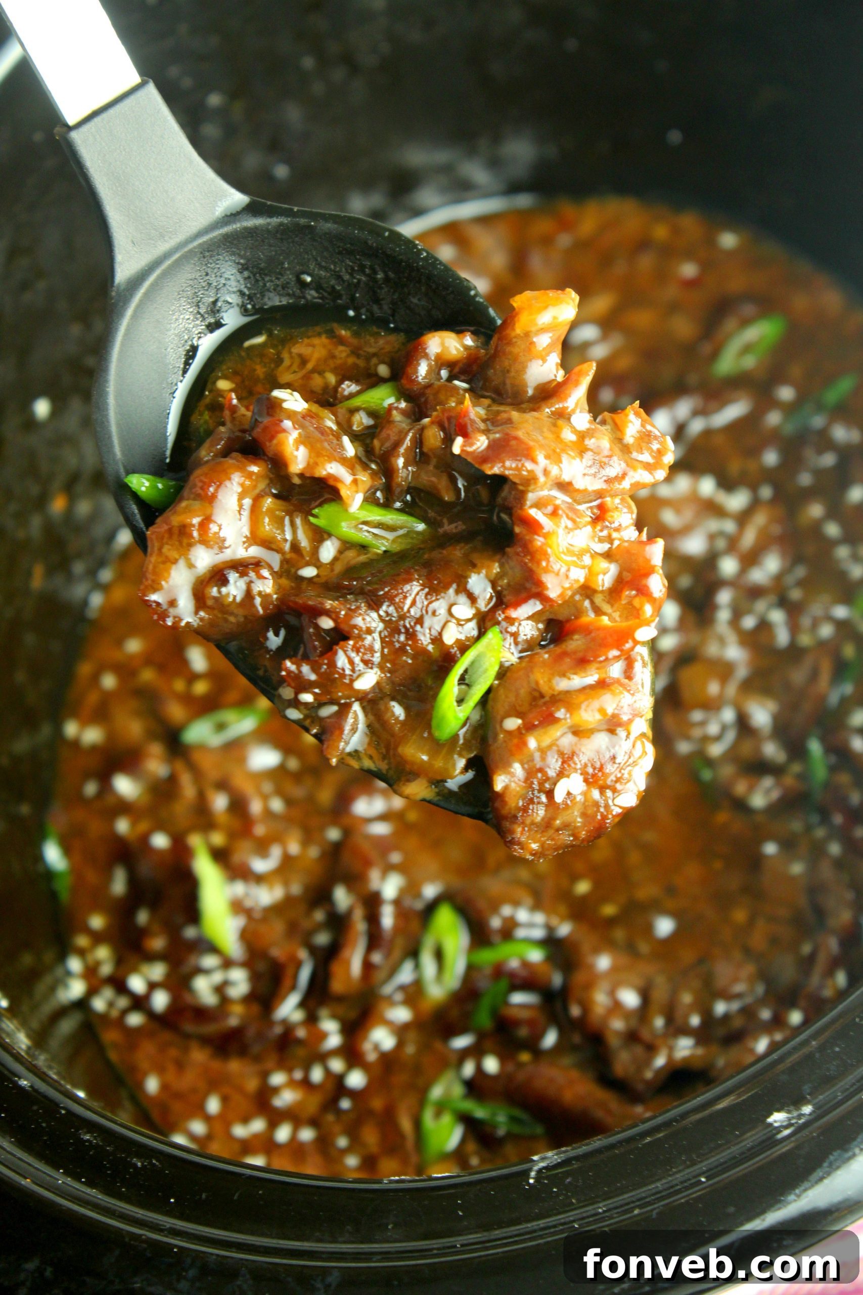 Slow Cooker Korean Beef with a serving spoon