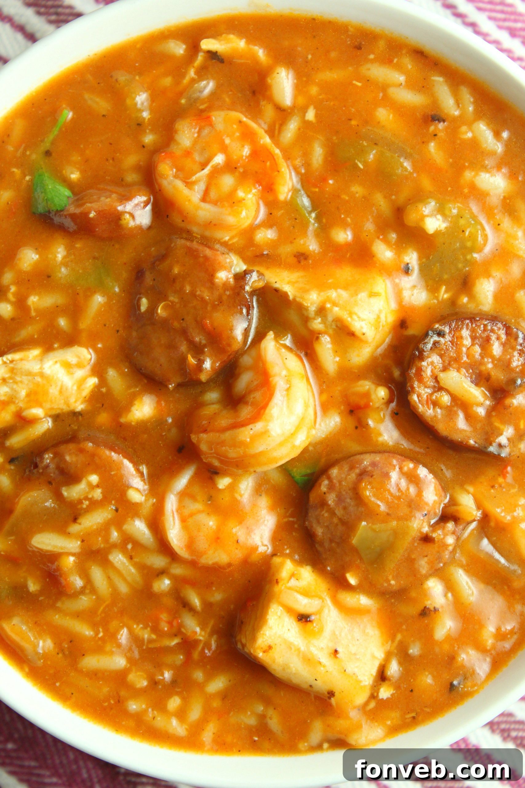 Spicy Cajun Jambalaya Soup 5 A close-up shot of the rich, thick broth of Jambalaya Soup, with chicken, sausage, and vegetables simmering.