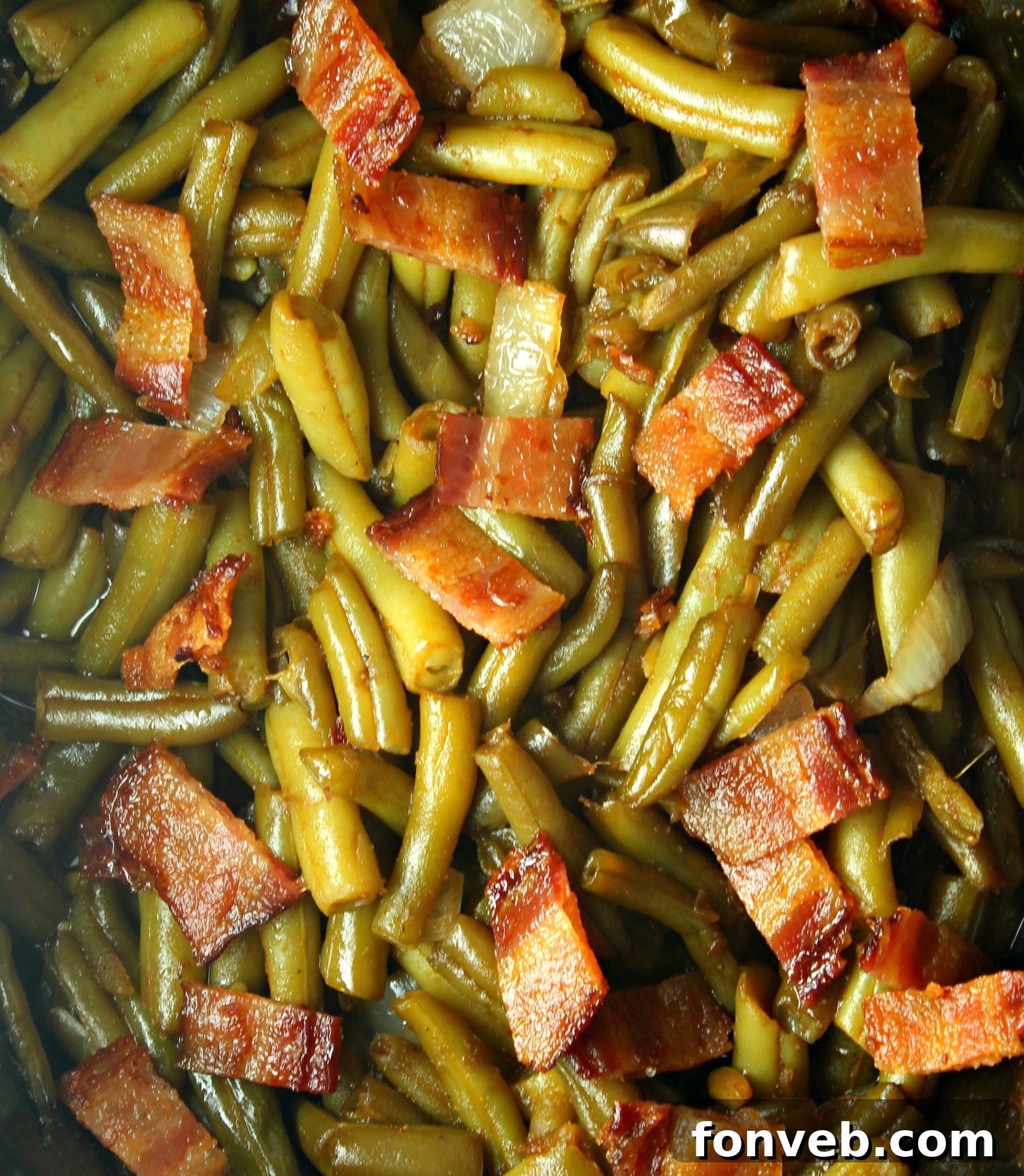 Close-up of Slow Cooker Buttery Bacon Green Beans in a rustic serving dish, beautifully showcasing the vibrant green beans and golden-brown crispy bacon bits.