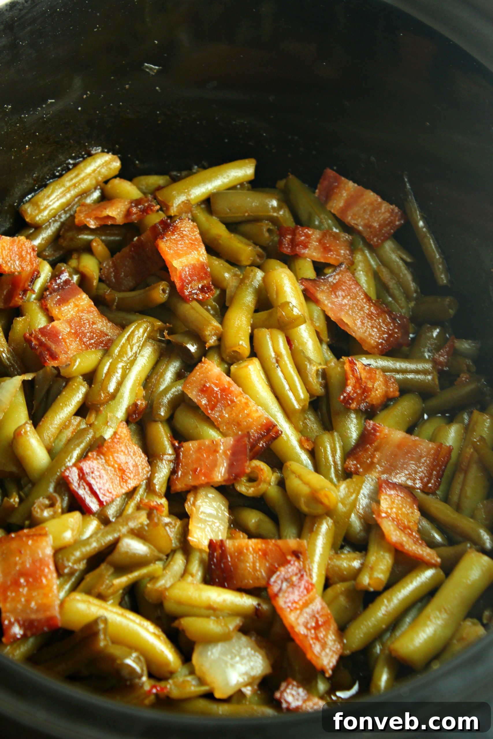 A beautifully plated serving of Slow Cooker Buttery Bacon Green Beans, garnished with fresh herbs, ready to be enjoyed.