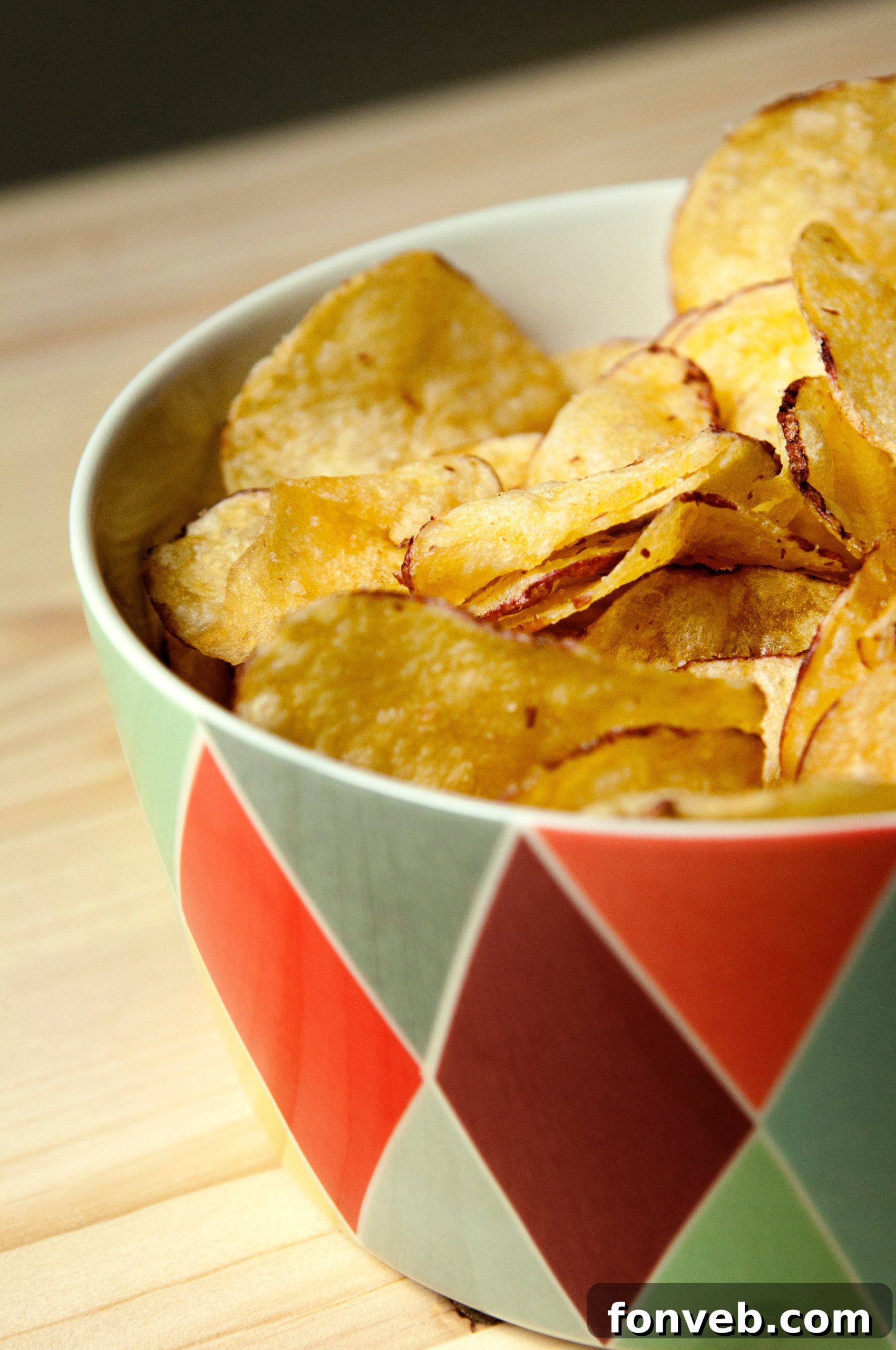 Close-up of a bowl of potato chips, representing unhealthy snacking