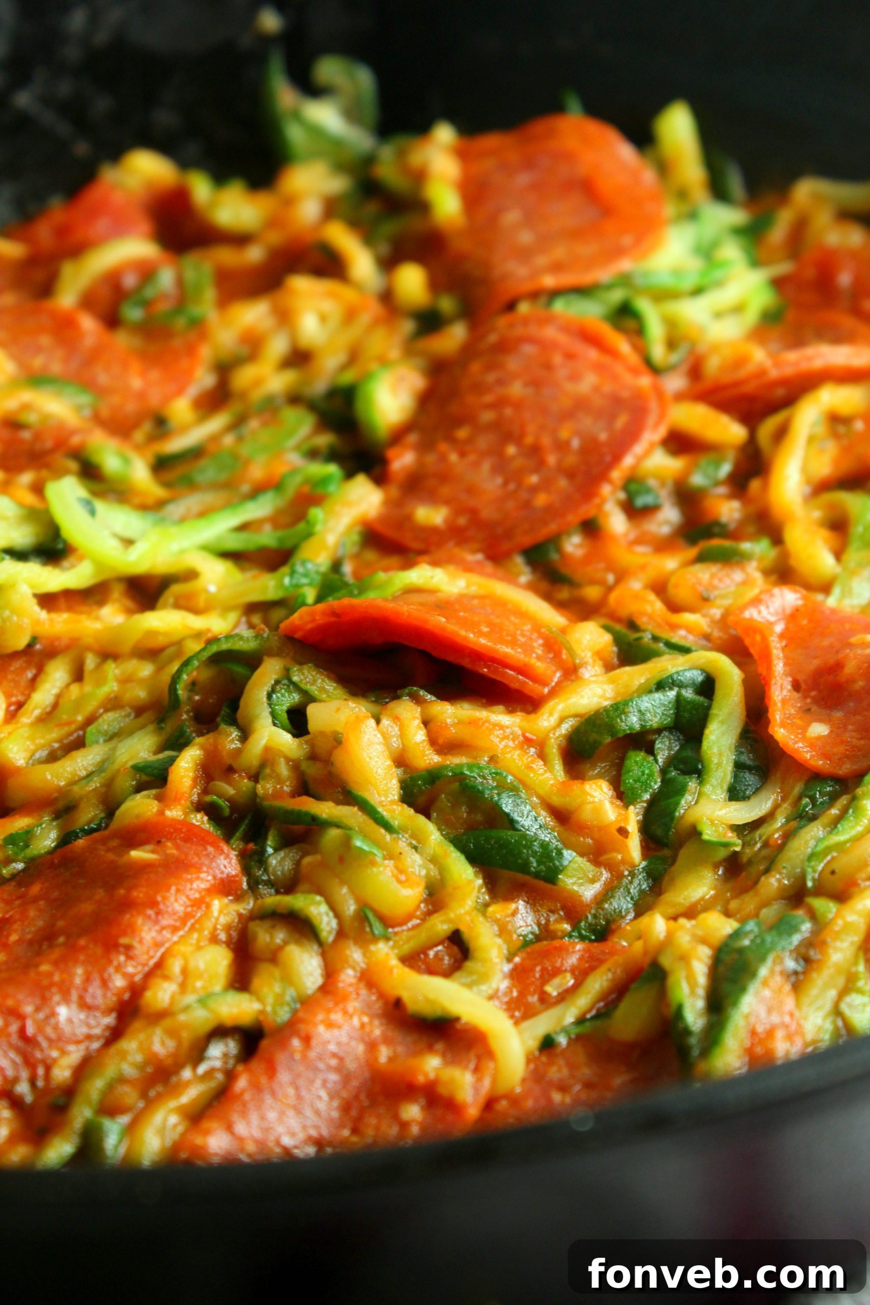 Close-up of freshly made zucchini noodles with sauce, ready to be cooked