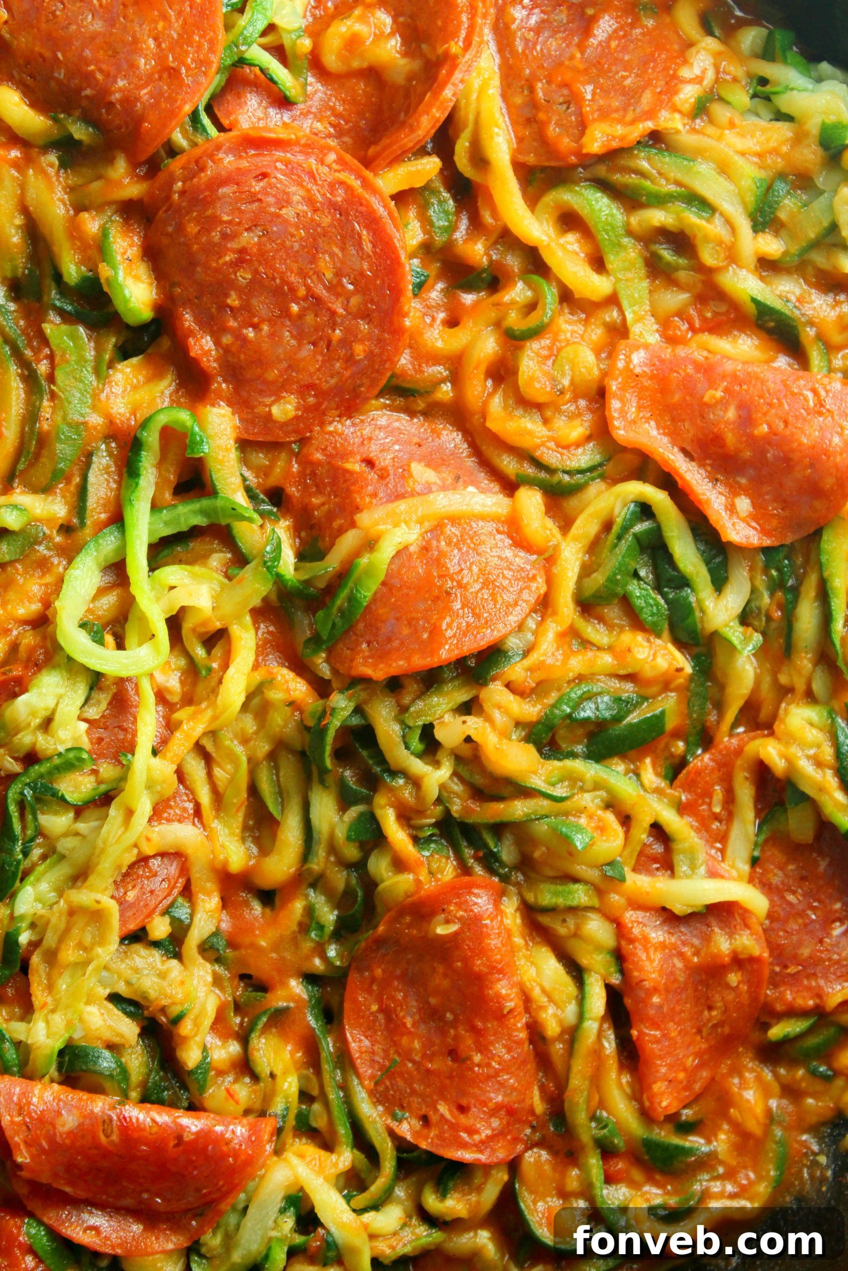 A beautifully plated dish of zucchini pasta with pepperoni and cheese