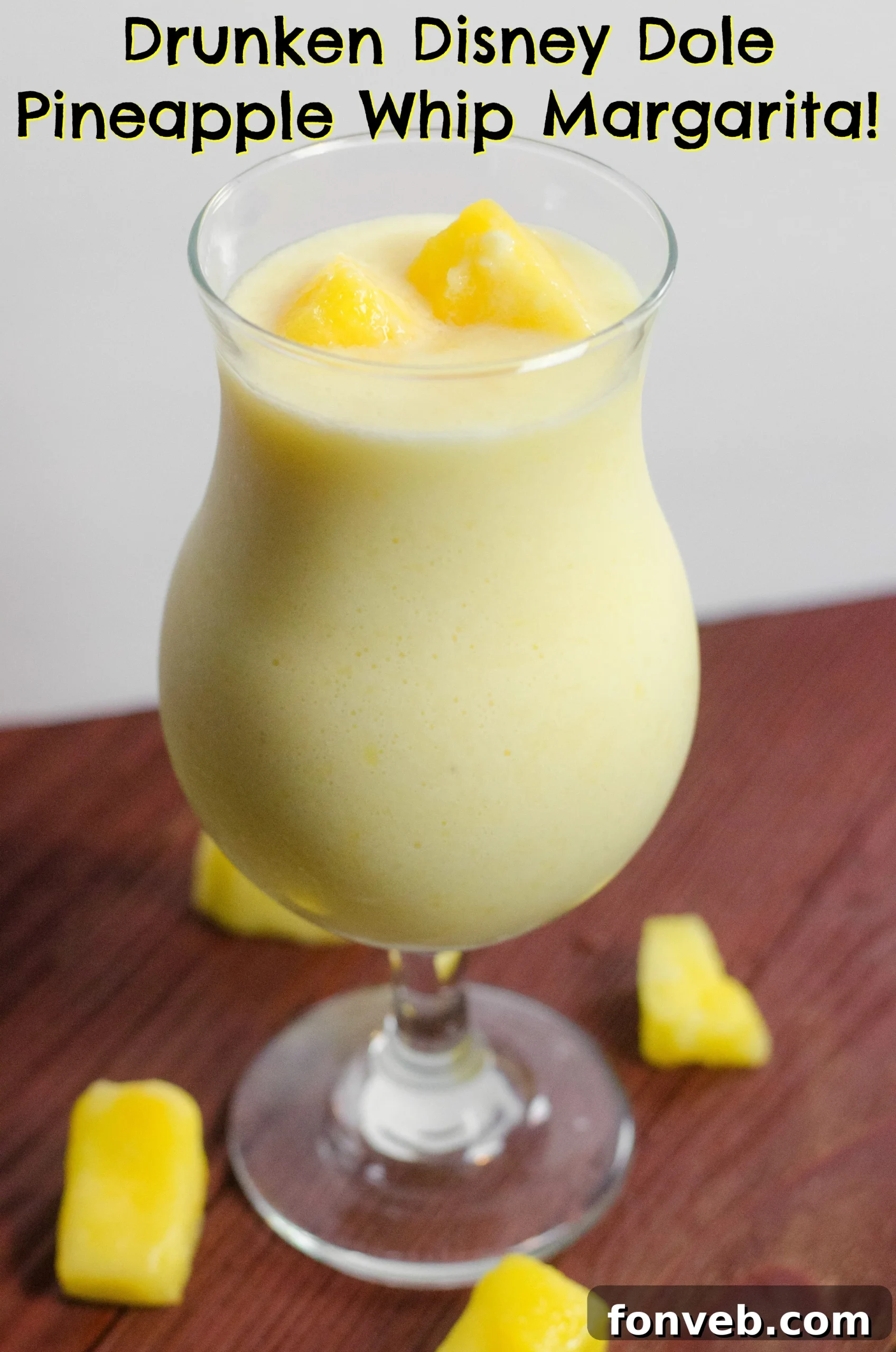 A refreshing Drunken Disney Dole Pineapple Whip Margarita in a tall glass, garnished with a pineapple slice.