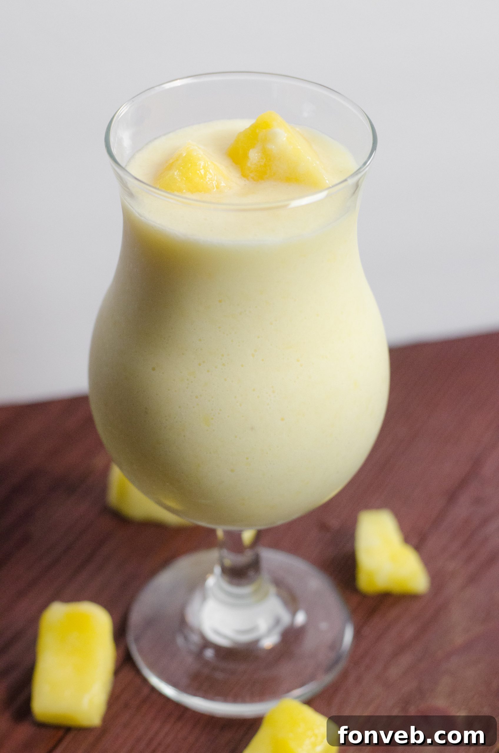 Close-up of a Drunken Disney Dole Pineapple Whip Margarita, showing its creamy texture and frothy top.