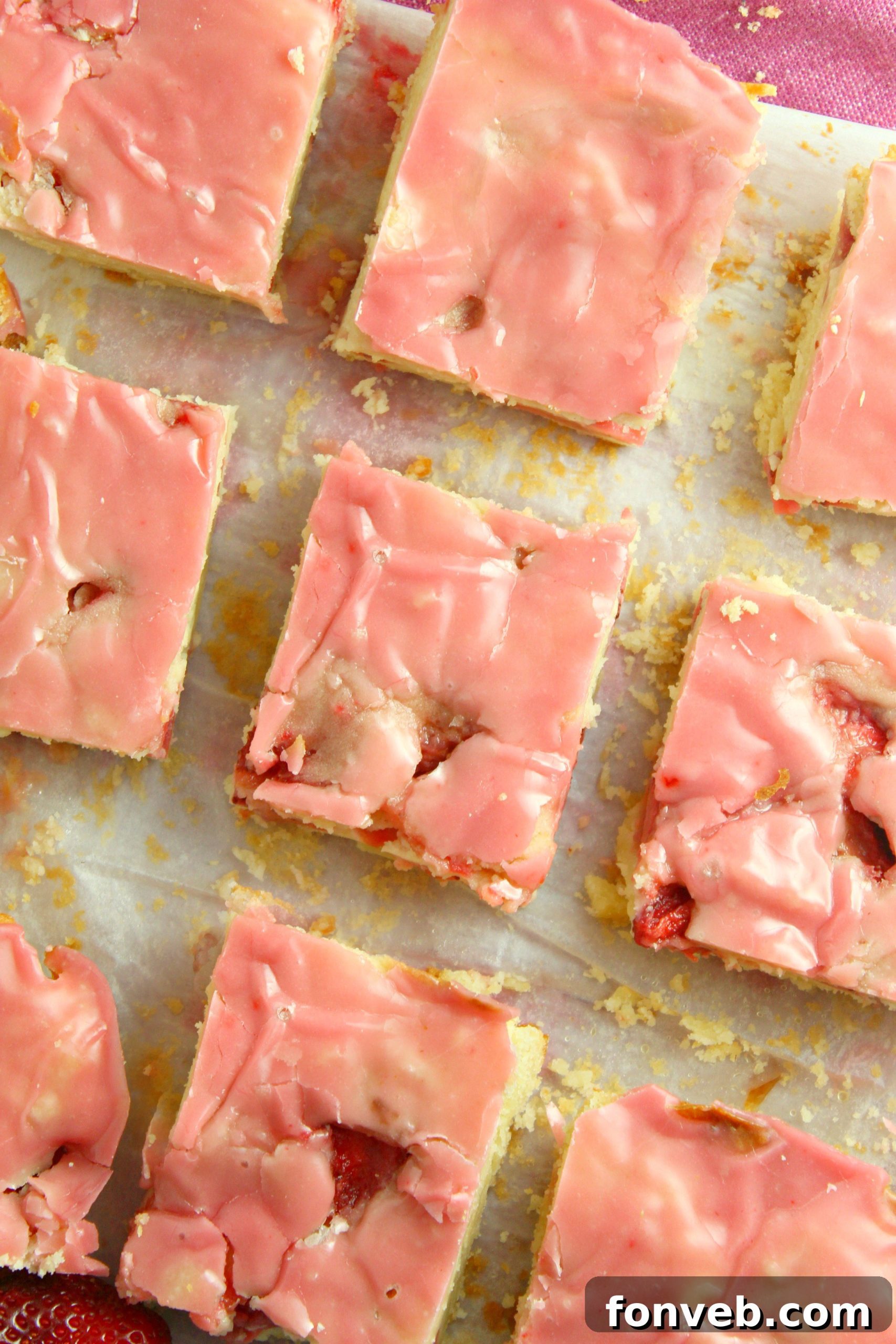 A baking pan filled with the blondie batter, showing the generous amount of diced strawberries mixed in, before baking.