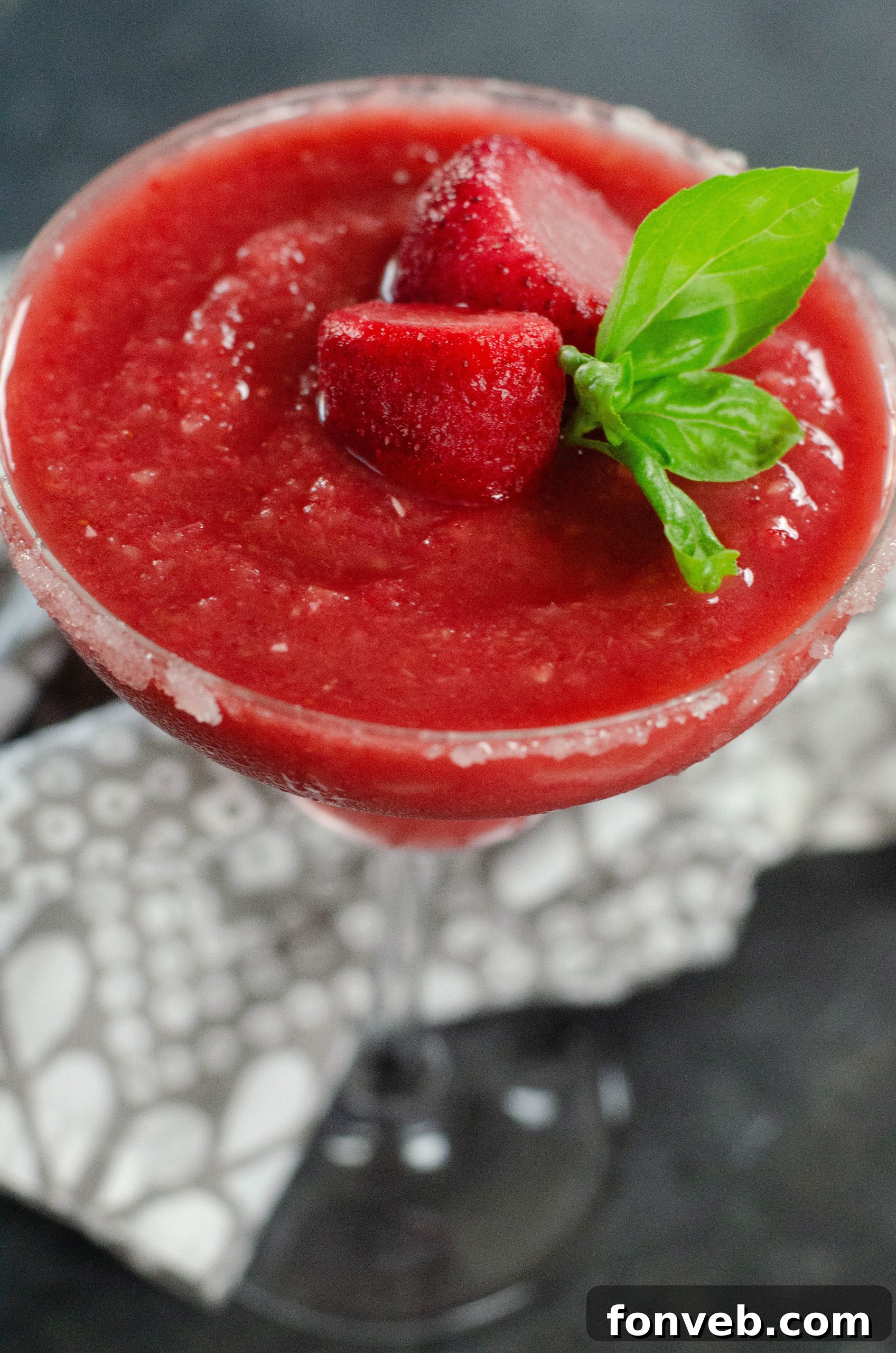 Frozen Strawberry Dream 2 Refreshing Strawberry Daiquiri cocktail in a tall glass, garnished with fresh strawberries.
