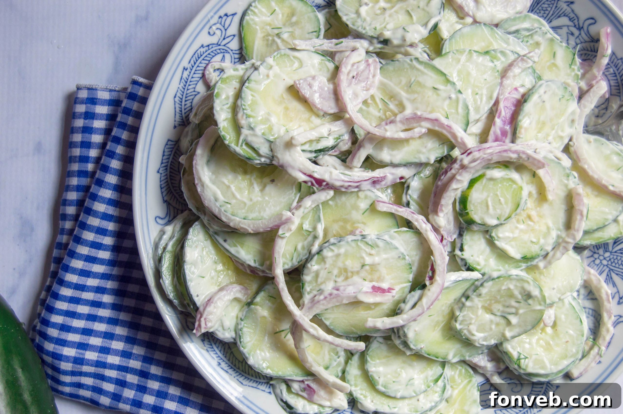 A generous serving of creamy cucumber salad in a bowl, highlighting the rich and smooth dressing.