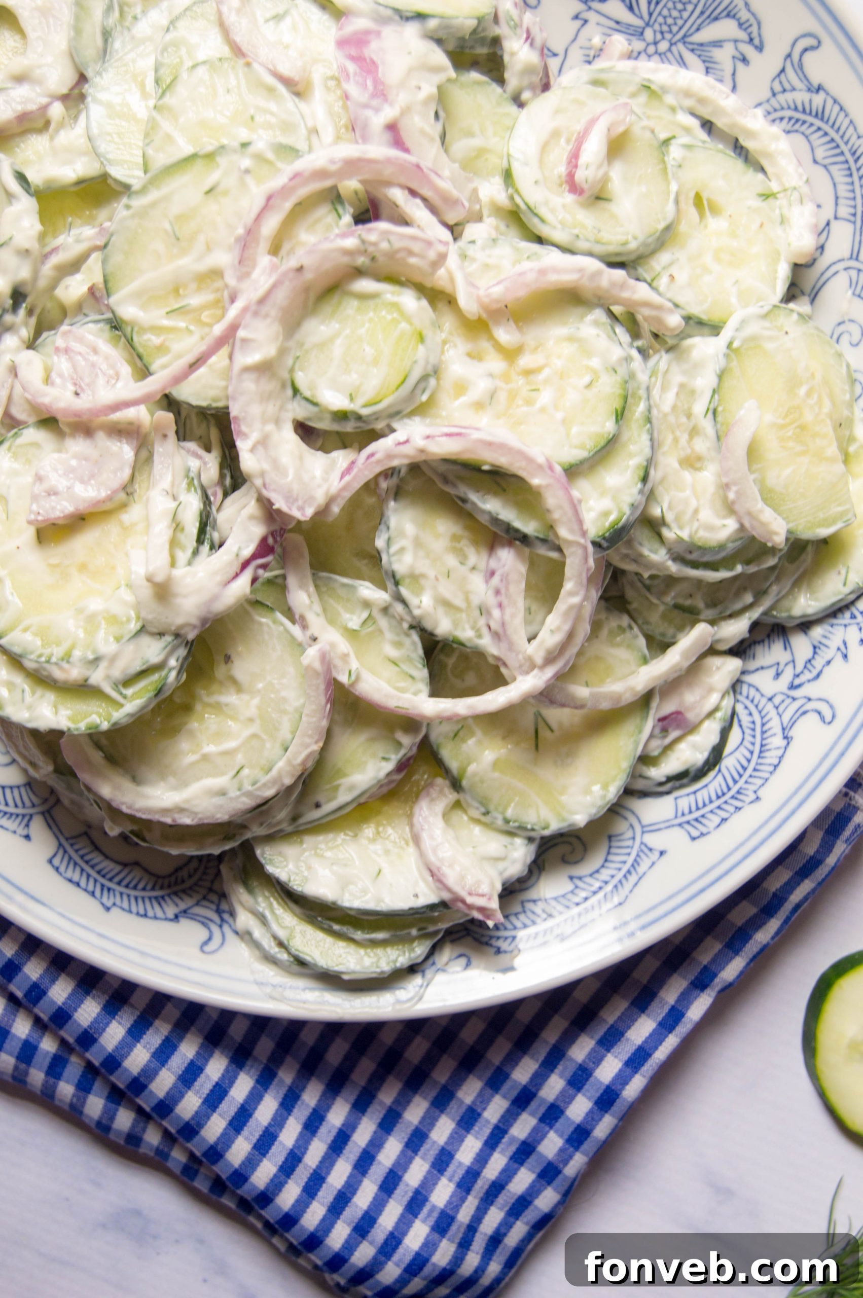A close-up shot of the creamy cucumber salad, emphasizing the fresh, crisp texture and the rich dressing, ready for serving.