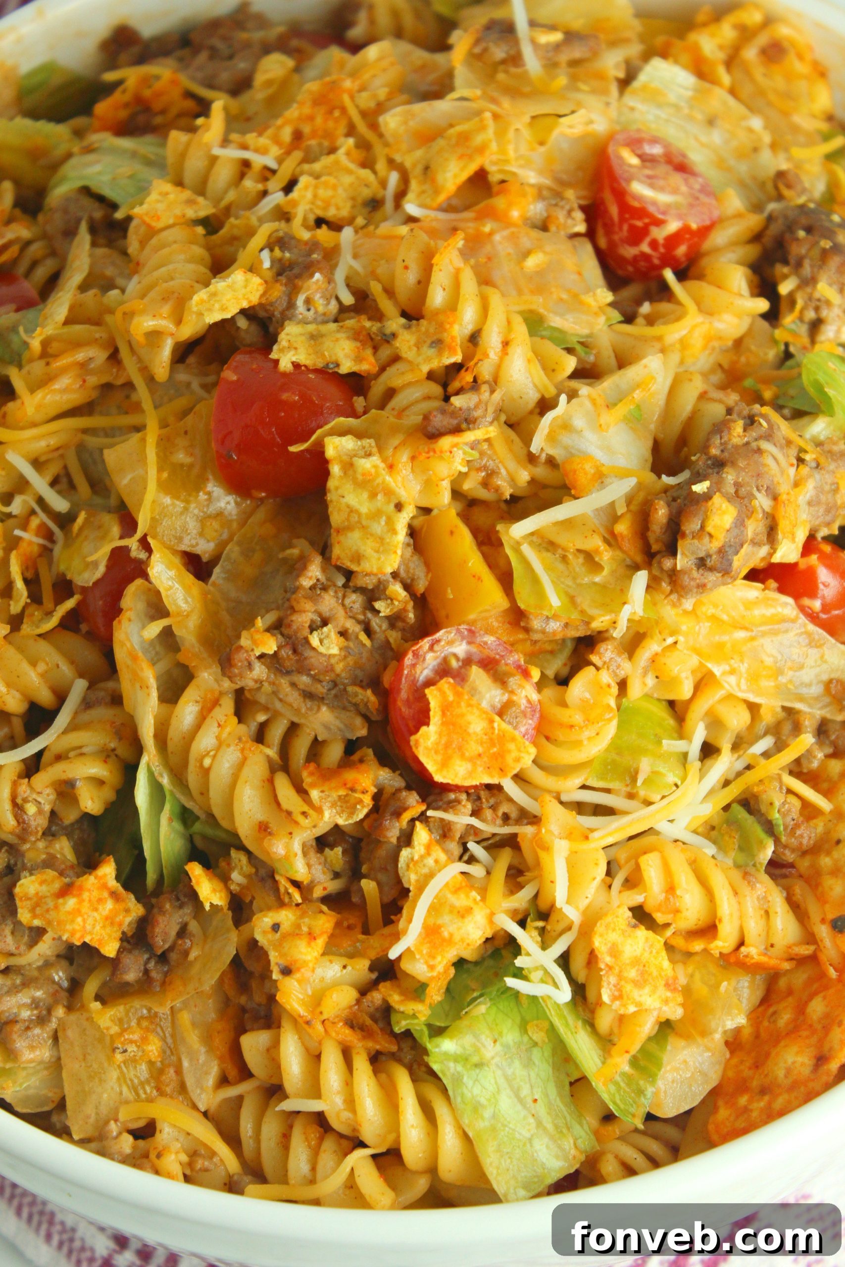 Doritos Locos Taco Pasta Salad in a white bowl with a spoon