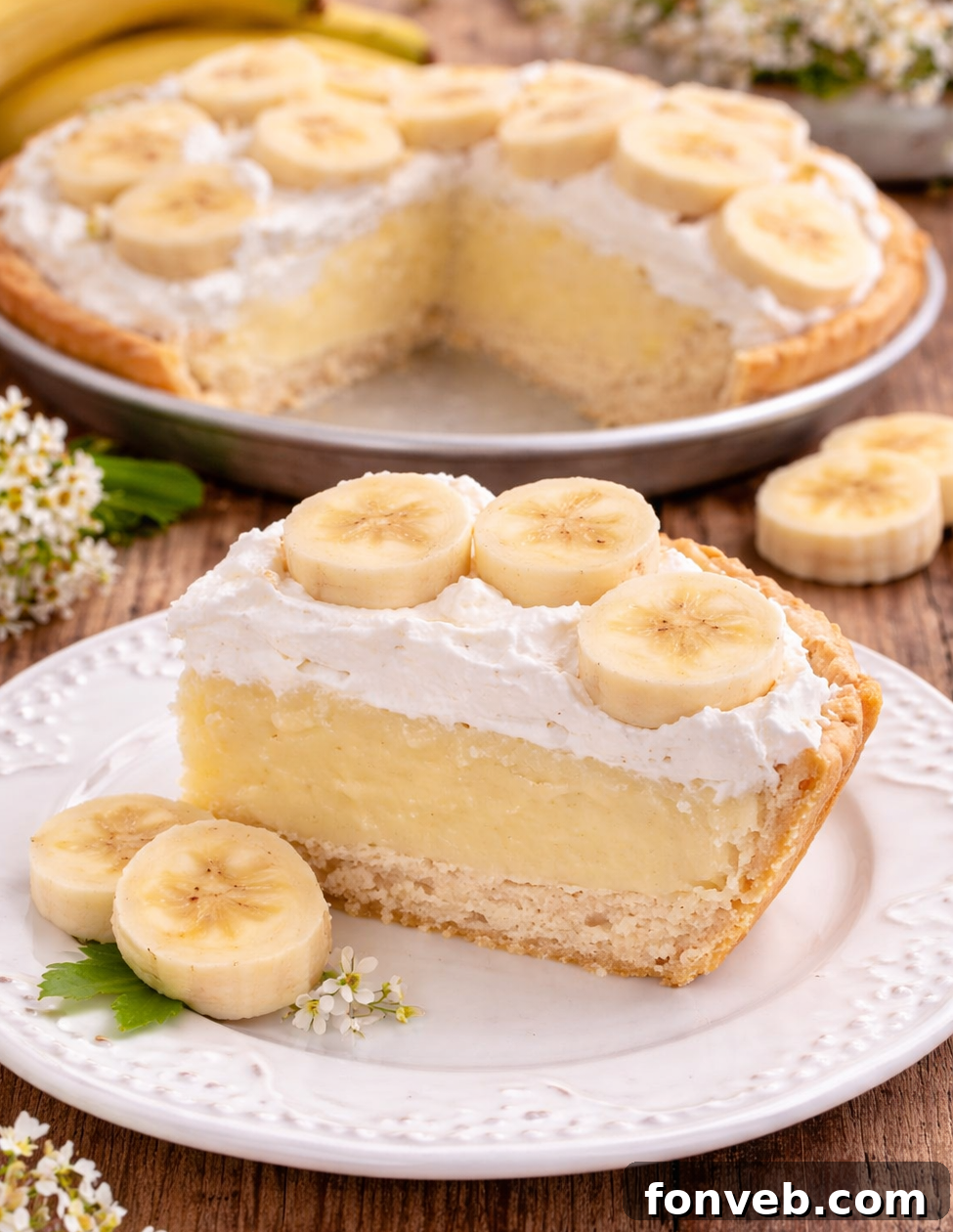 Grandma's Banana Cream Dream 4 A beautifully decorated Old Fashioned Banana Cream Pie with tall, elegant whipped cream peaks, ready for a special occasion.