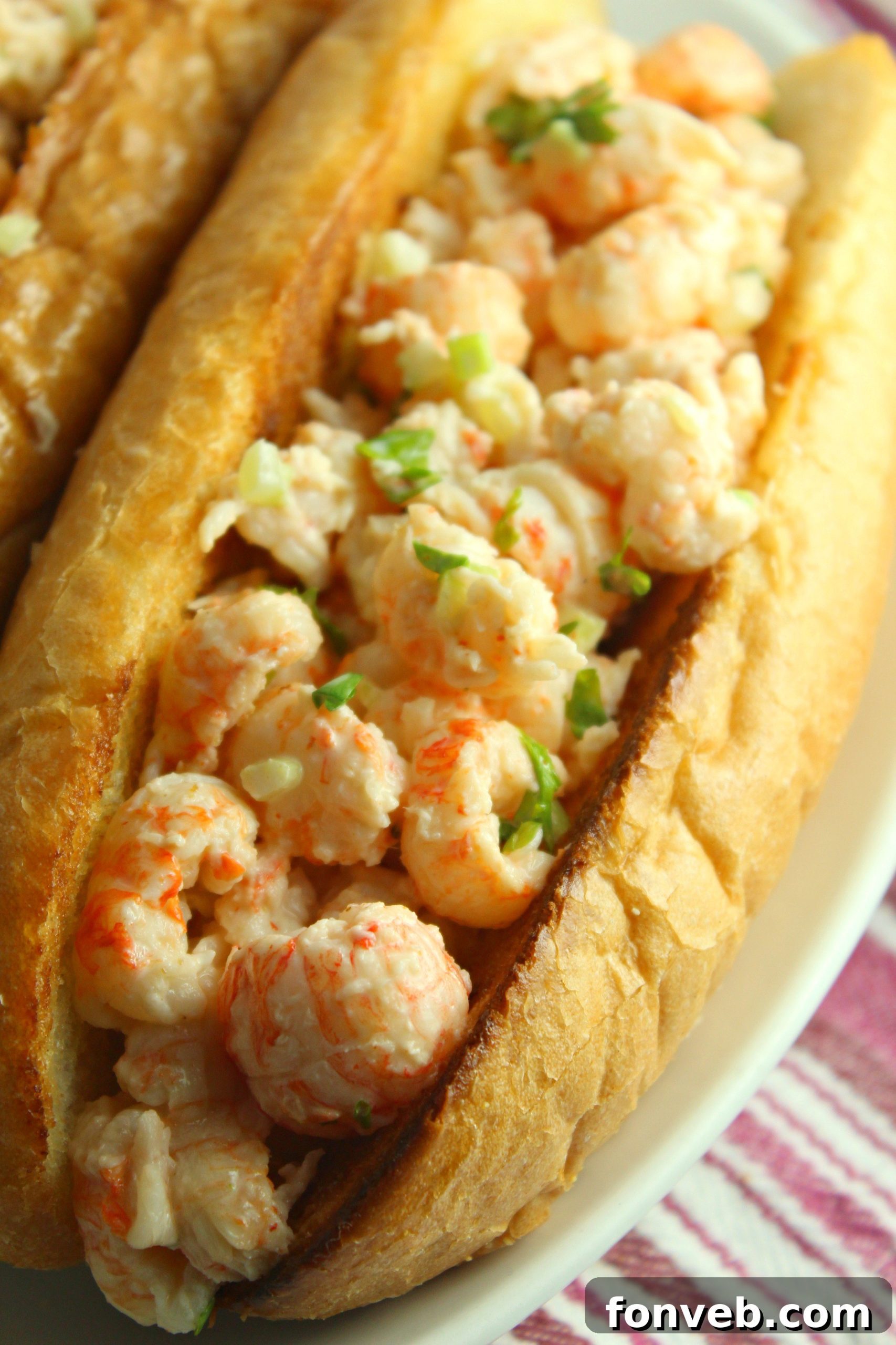 A close-up of a perfectly filled lobster roll