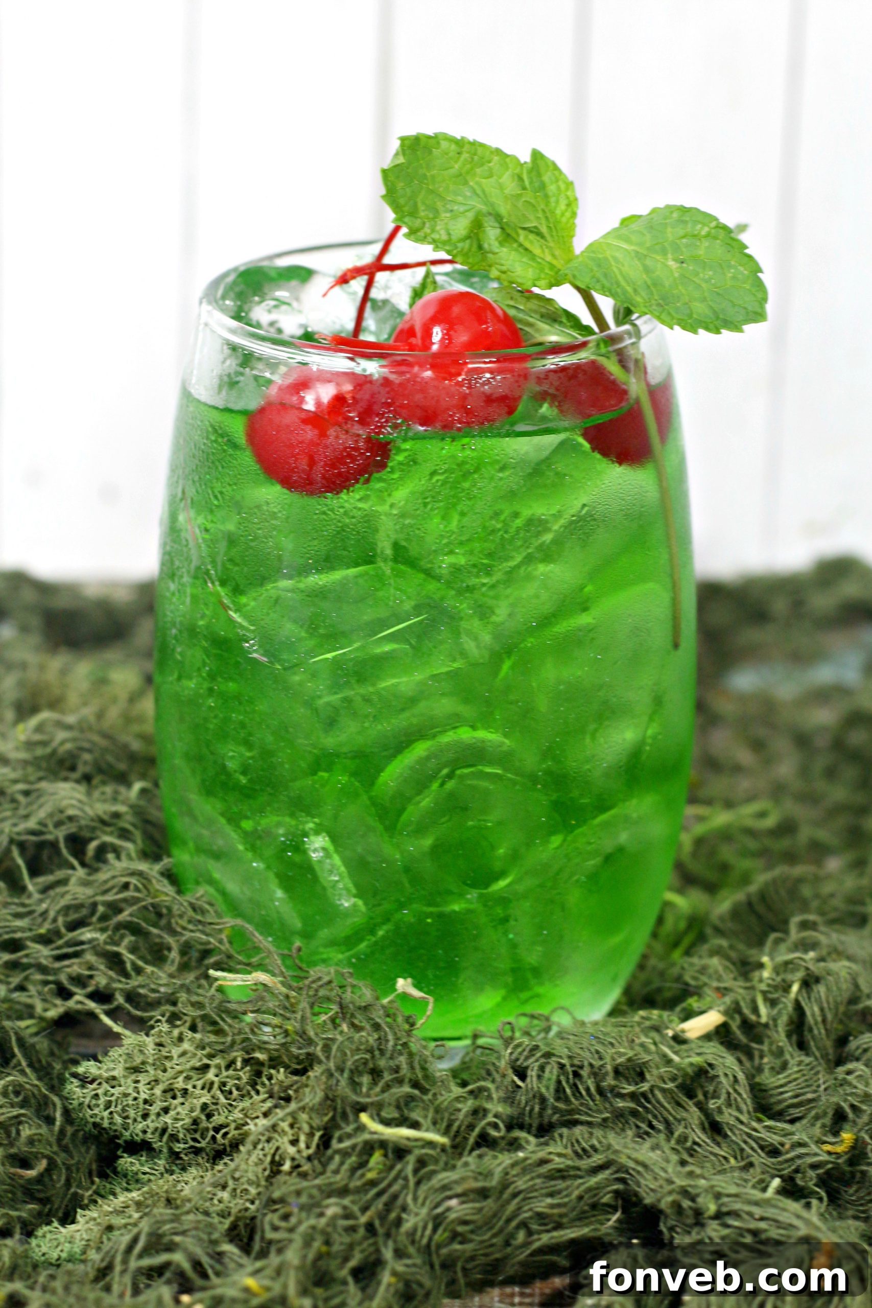A Liquid Marijuana Cocktail with a prominent lime wedge garnish.