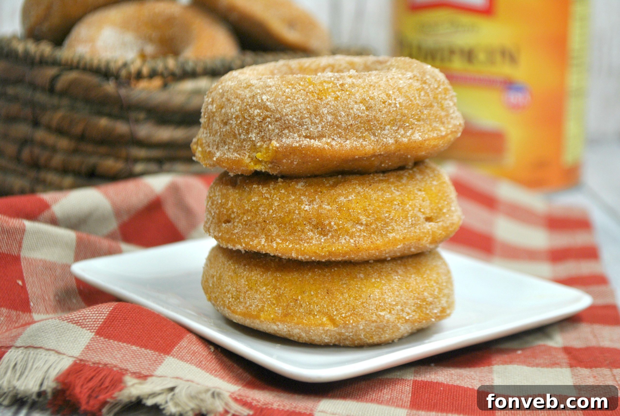 Spiced Autumn Donut Perfection 4 Freshly baked pumpkin spice donuts on a cooling rack, ready to be coated