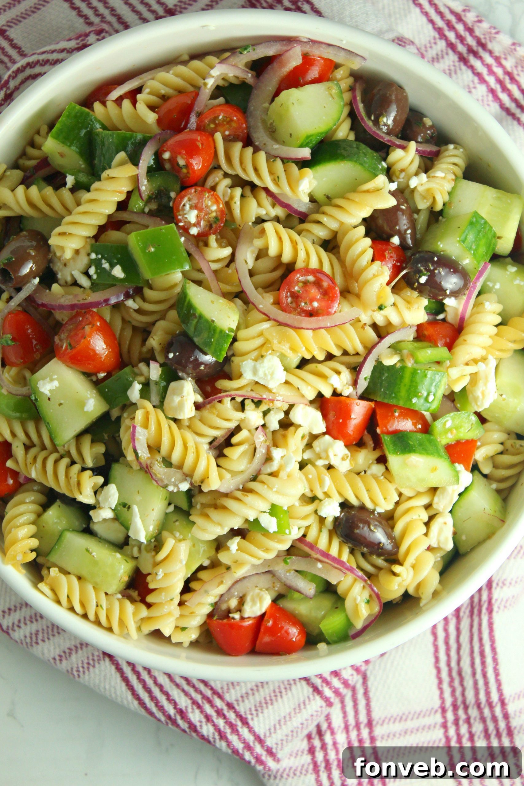 A close-up of Greek Pasta Salad, showing the texture of the pasta and crumbled feta cheese.