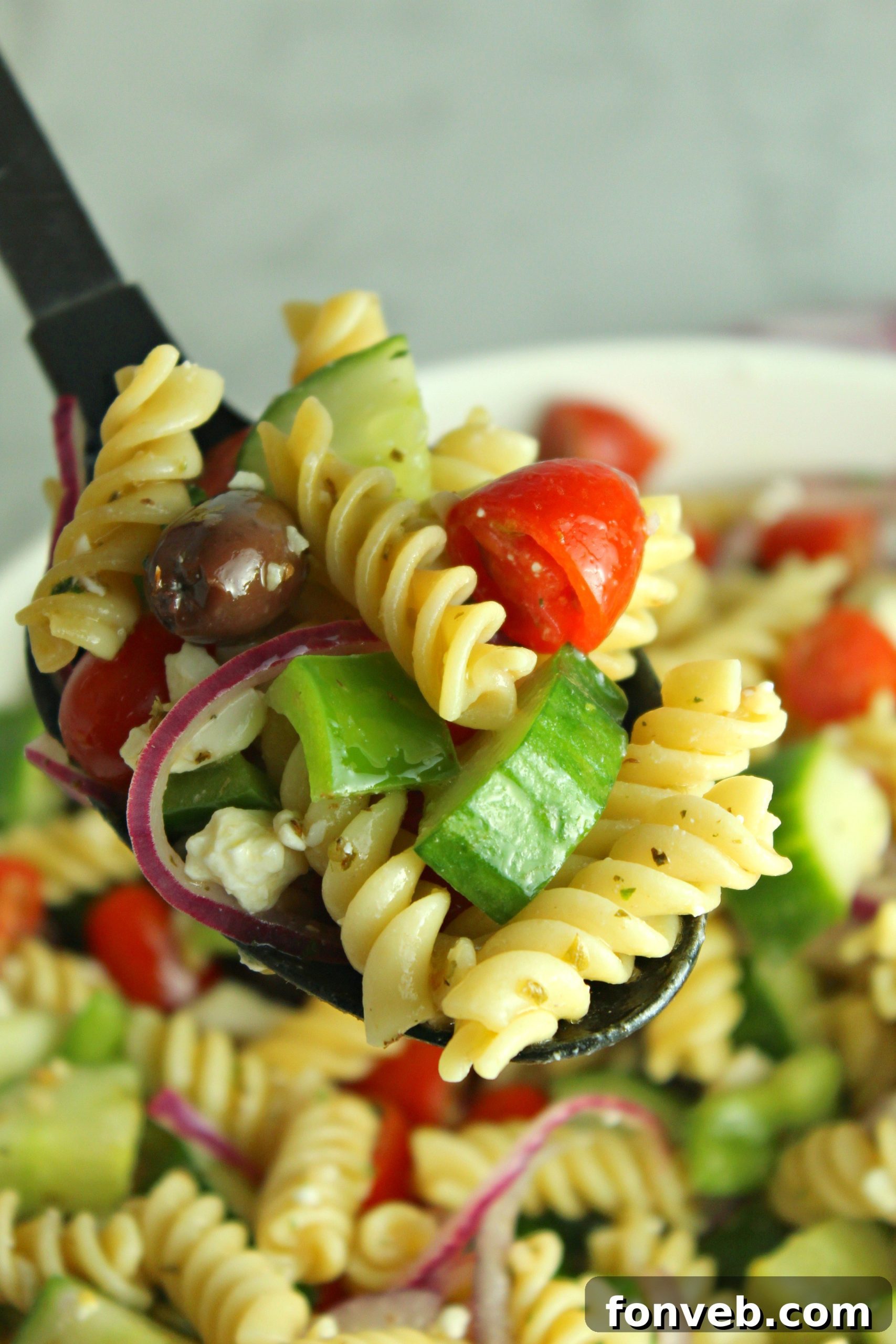 Another perspective of the Greek Pasta Salad in a serving dish, highlighting its fresh appeal.