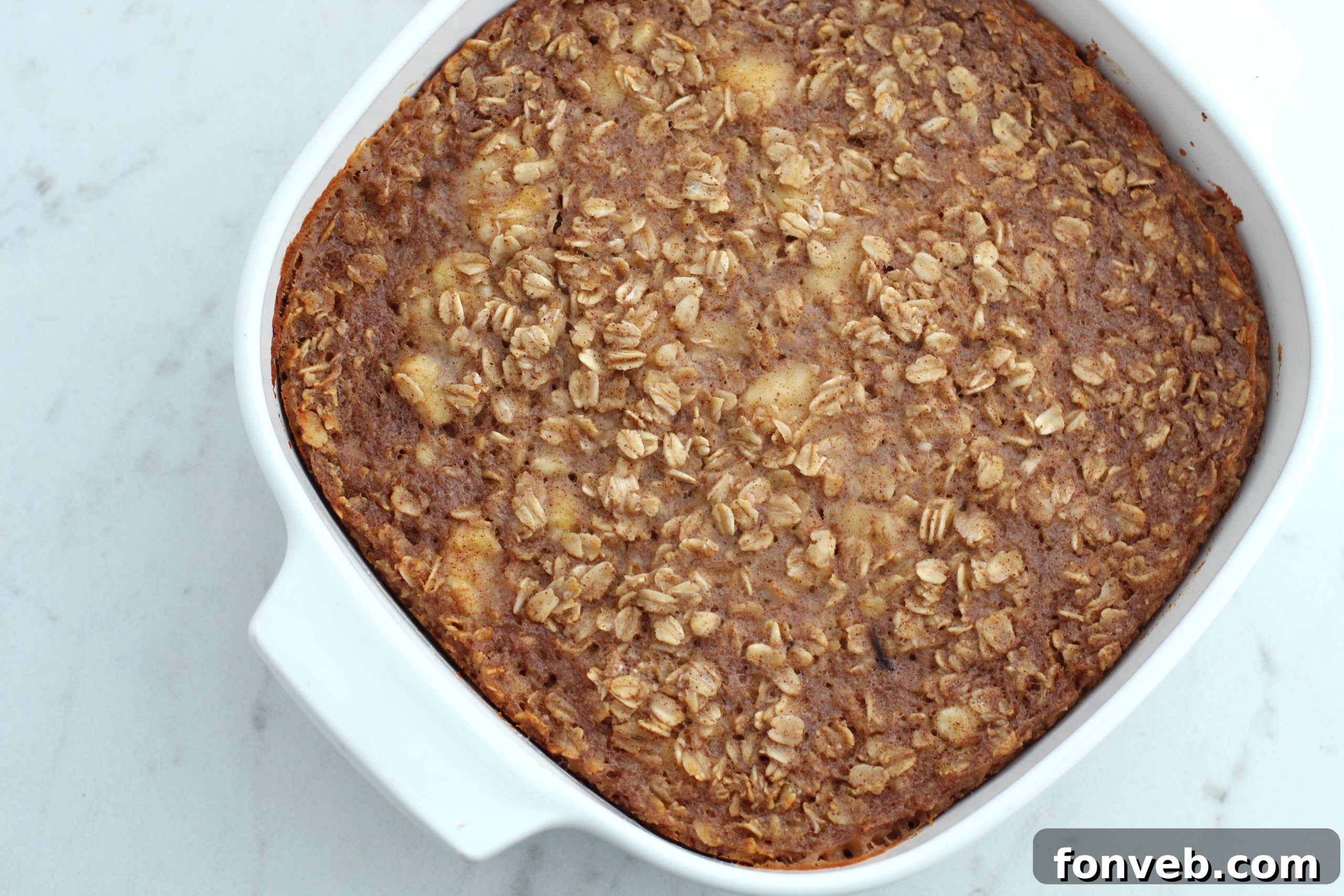 Freshly baked Banana Bread Oatmeal Bars in a baking dish, cut into squares.