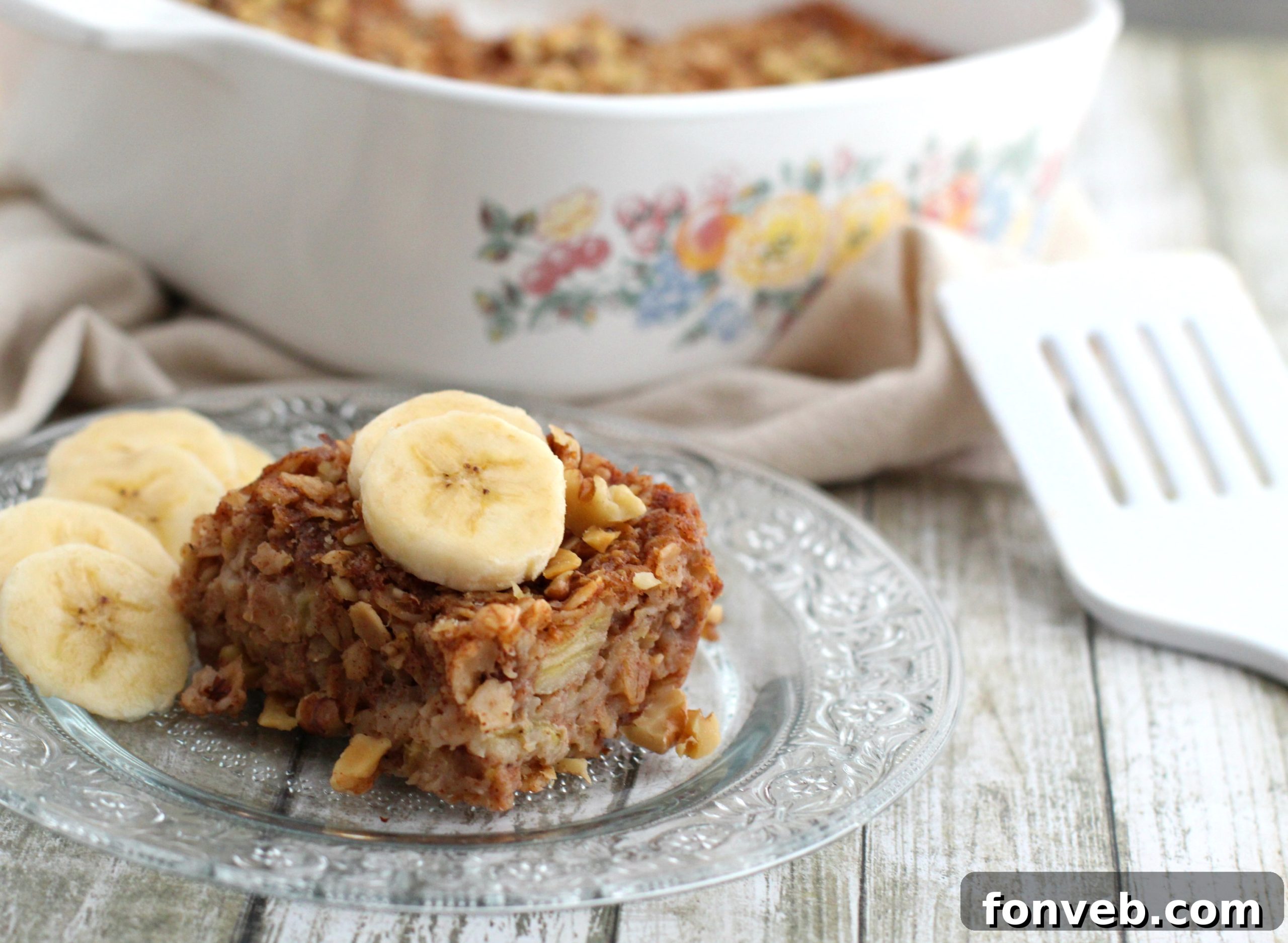 A close-up shot of a single Banana Bread Oatmeal Bar, showing its moist texture and oats.