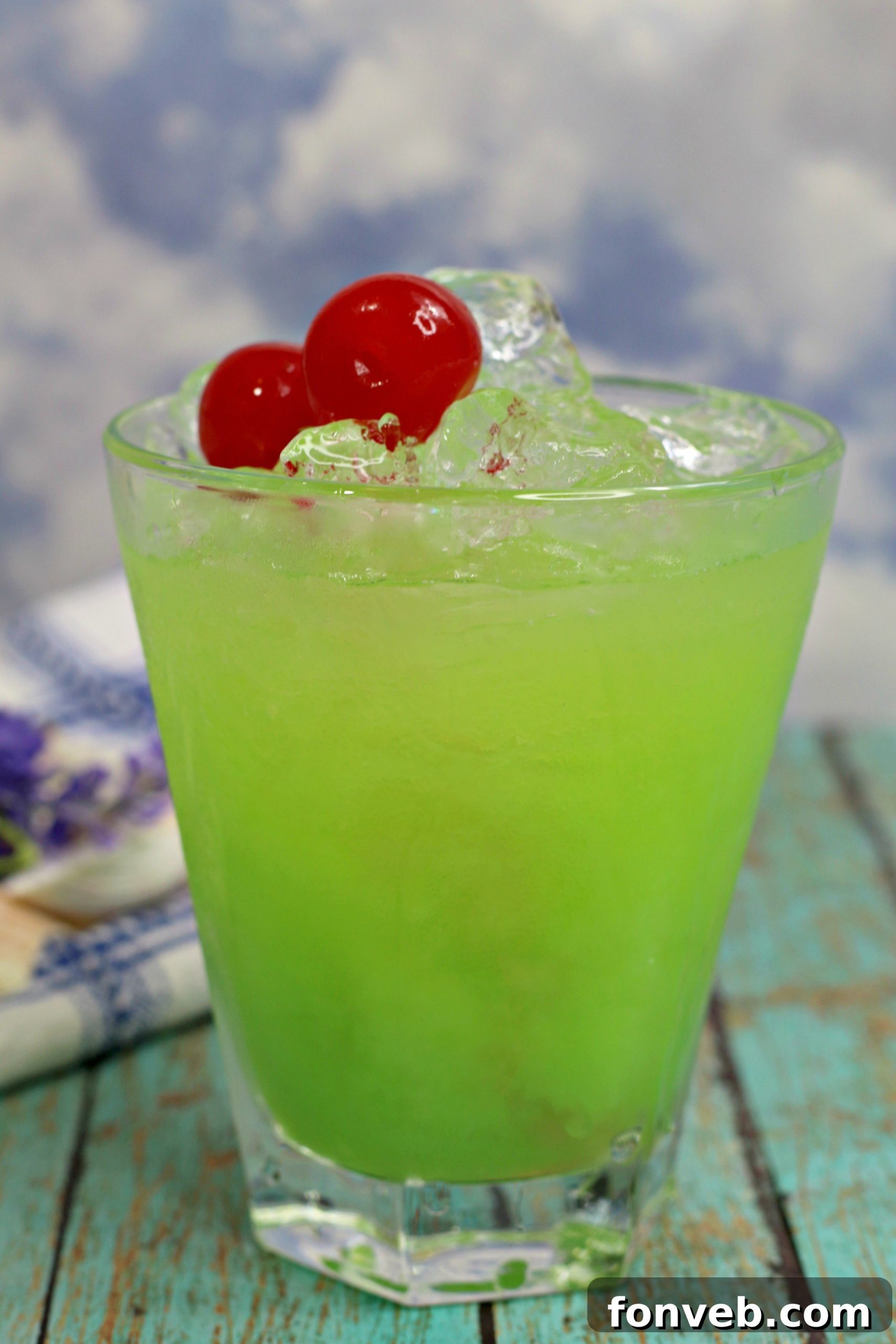 Ingredients for Green Iguana Cocktail laid out with a shaker, emphasizing fresh, vibrant components.