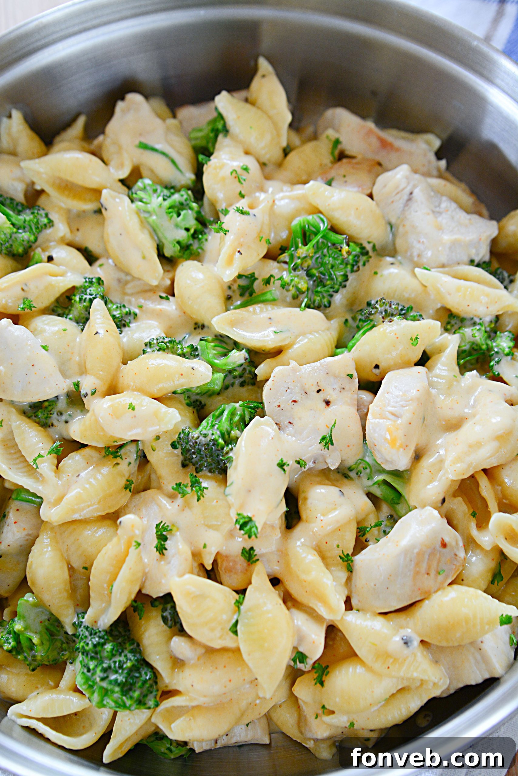 Creamy Cheesy Chicken and Broccoli Shells 8 A large pot of Cheesy Chicken & Broccoli Shells being mixed, showcasing the quantity and readiness of the dish.