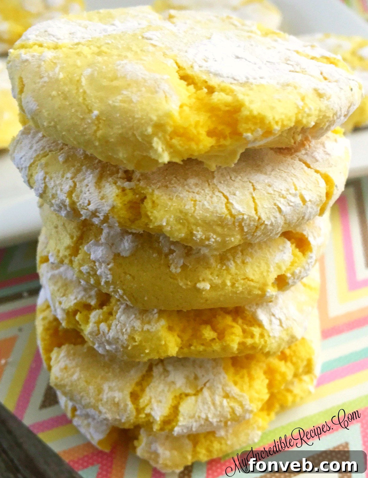 Zesty Lemon Crinkle Cookies 2 lemmain - Plate of freshly baked Lemon Crinkle Cookies, dusted with powdered sugar