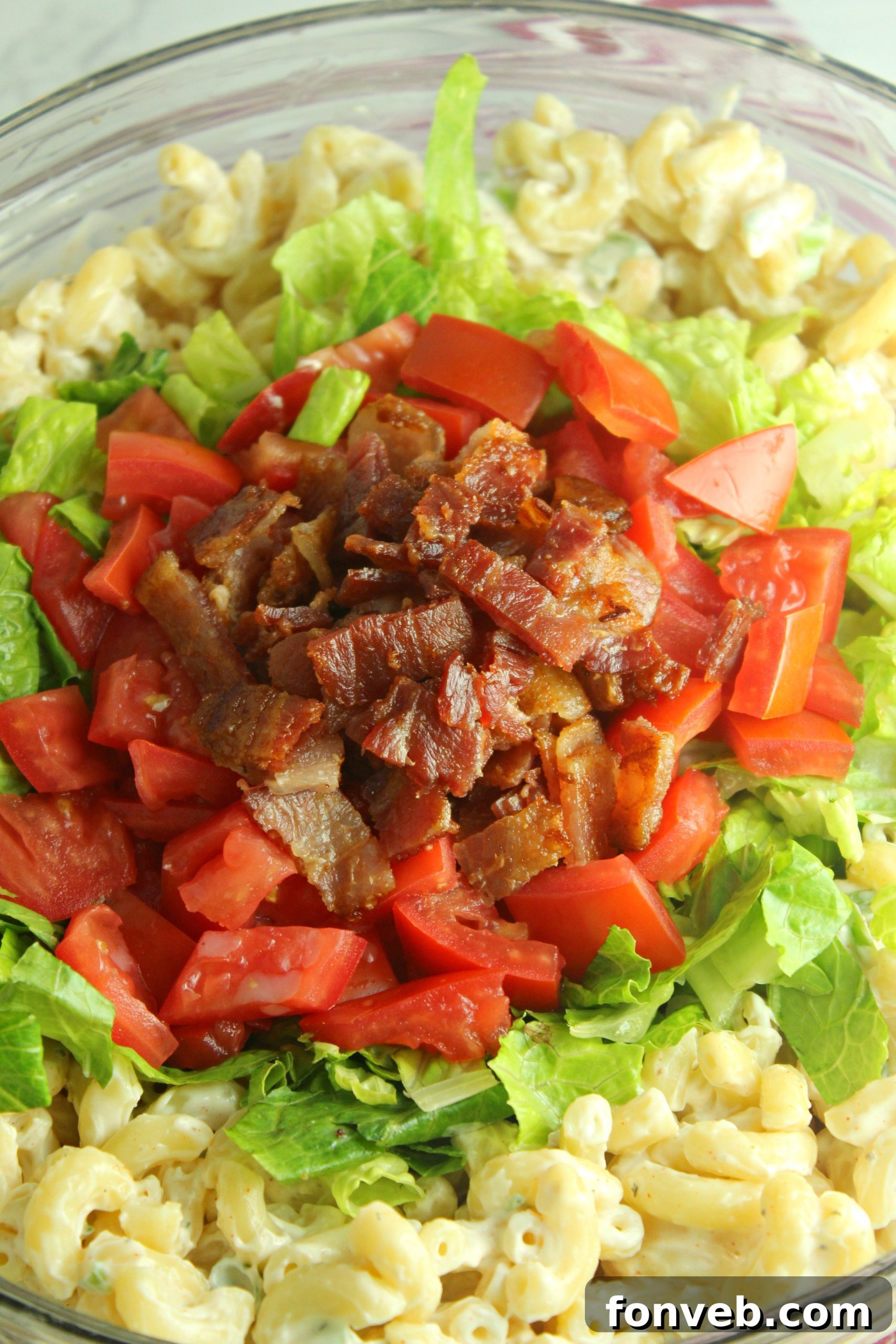 Close-up of BLT Pasta Salad, showcasing the crumbled bacon, diced tomatoes, and pasta coated in dressing.