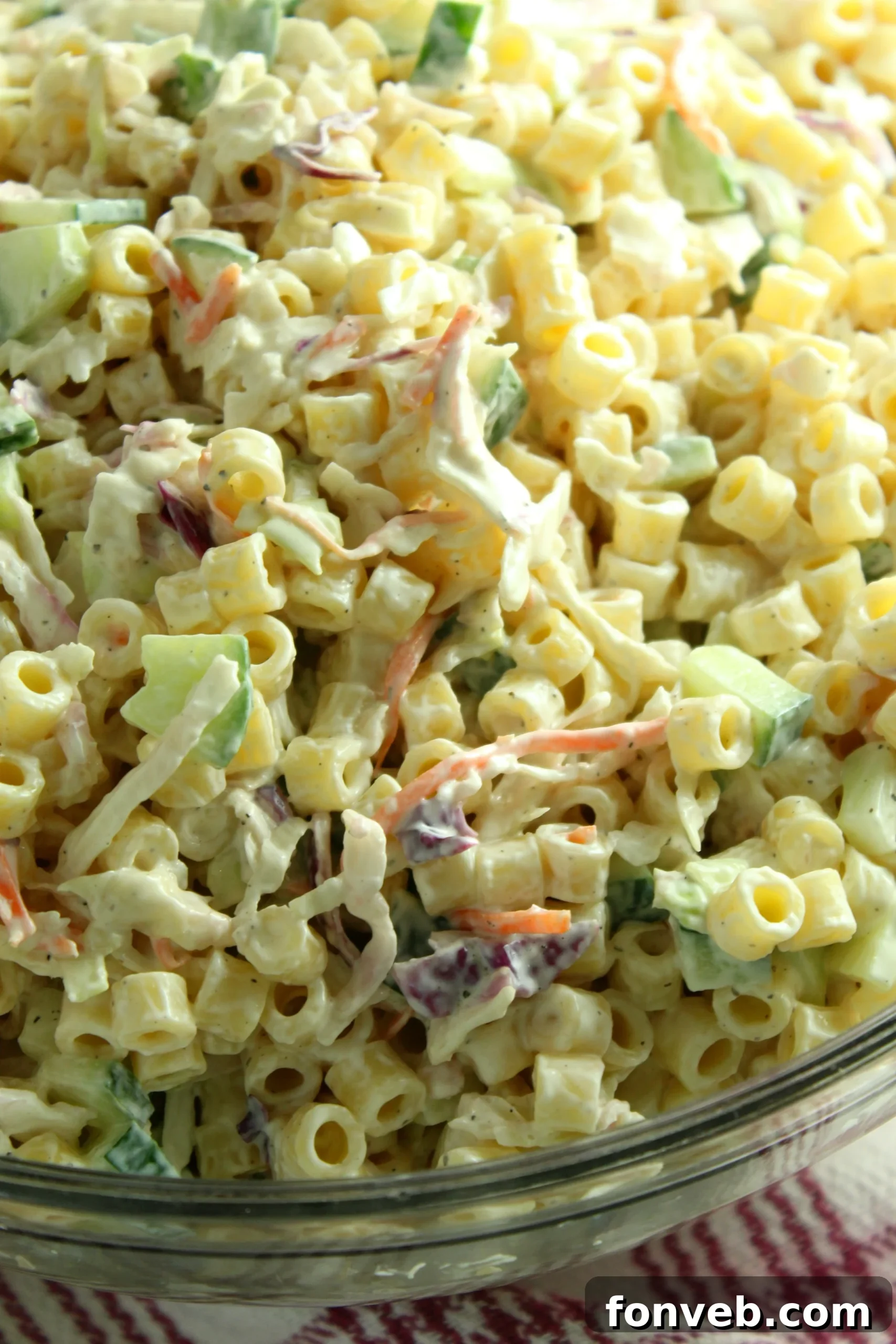 Coleslaw Pasta Salad with a serving spoon, highlighting its creamy dressing.