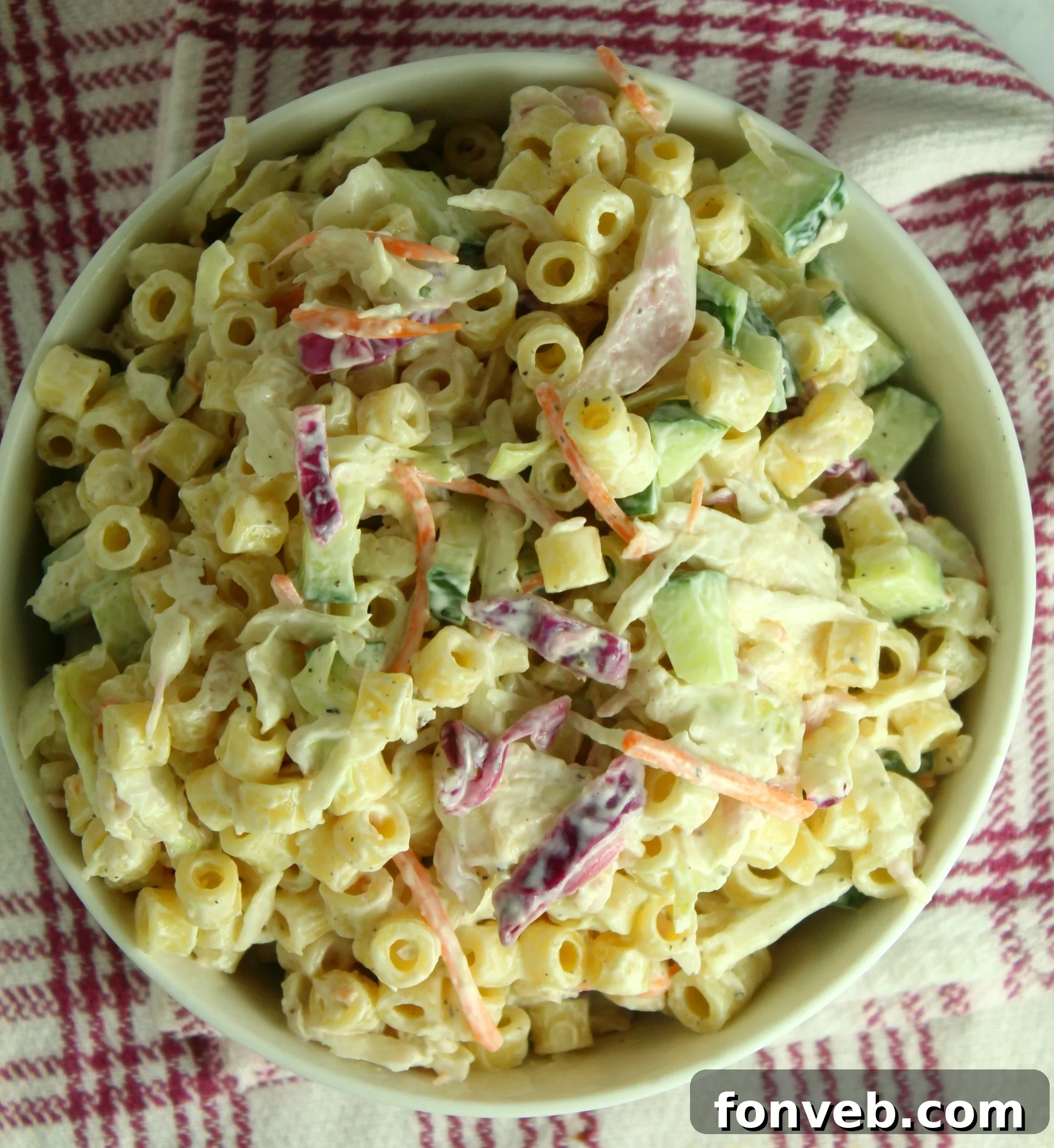A large serving bowl filled with Coleslaw Pasta Salad, ready for guests.