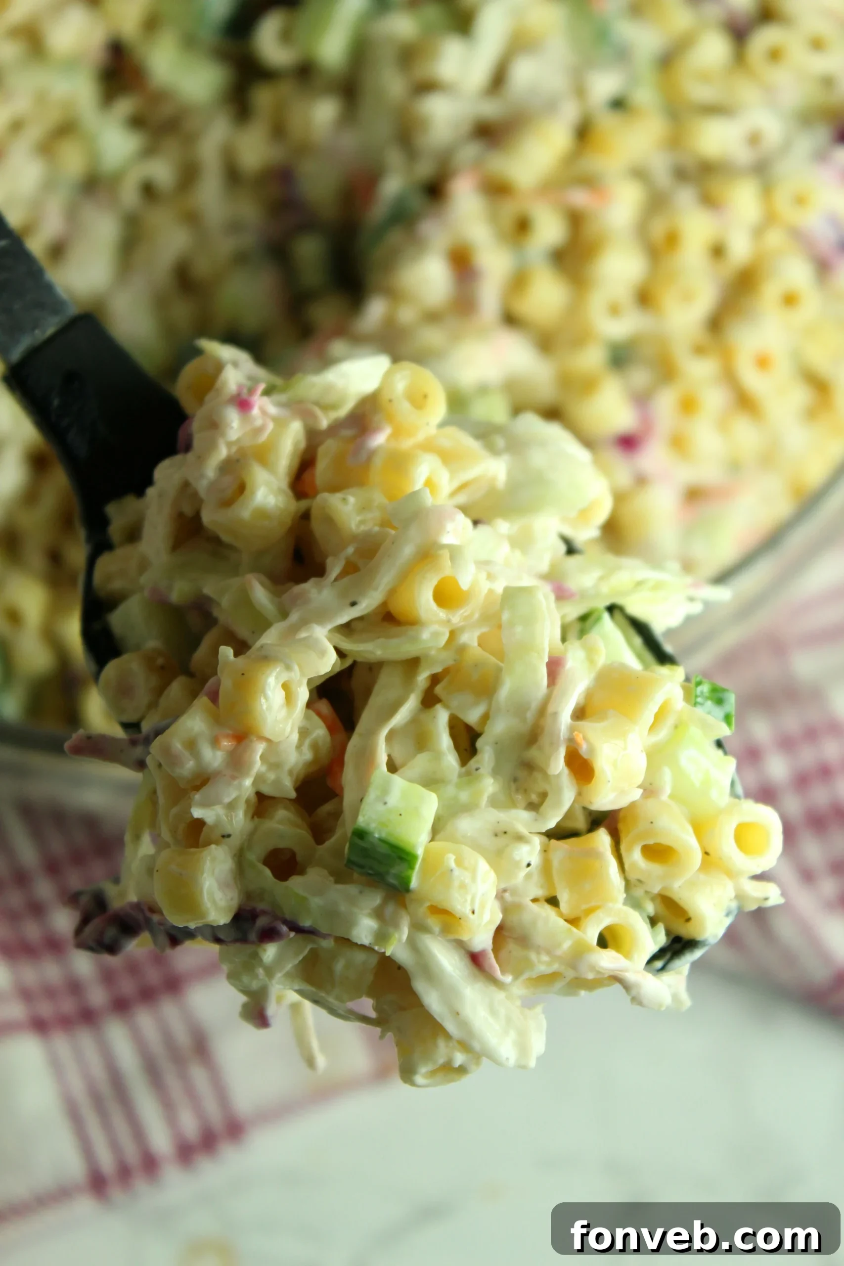 A close-up of the dressing being poured over the Coleslaw Pasta Salad.