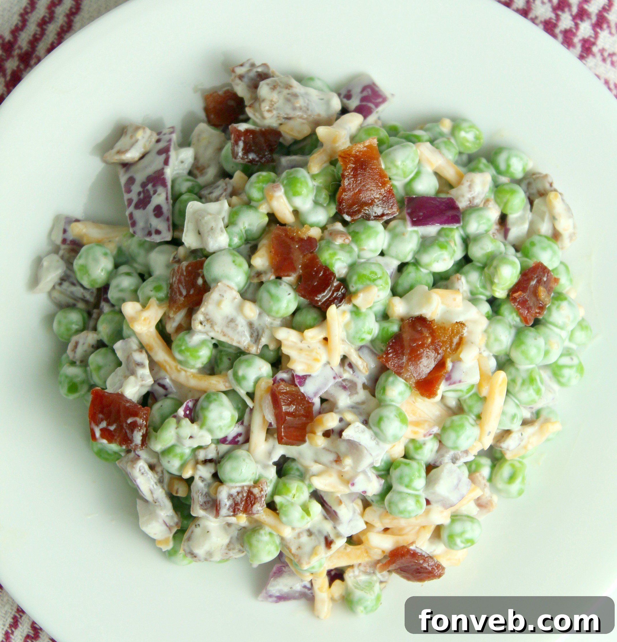 Smoky Bacon and Sweet Pea Salad 5 A closer look at the Creamy Bacon Pea Salad, emphasizing the rich texture of the dressing and the visible ingredients.