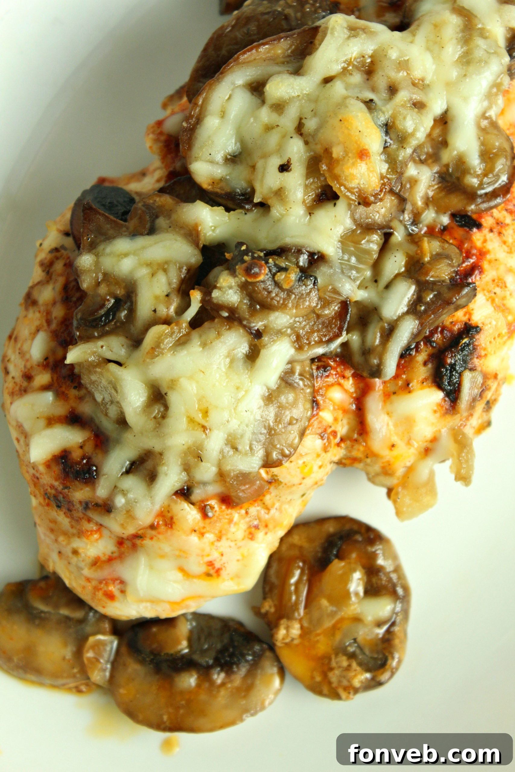 Creamy Cheesy Mushroom Chicken Keto Bake 8 A close-up overhead shot of the baked chicken, showcasing the melted cheese, onions, and mushrooms.