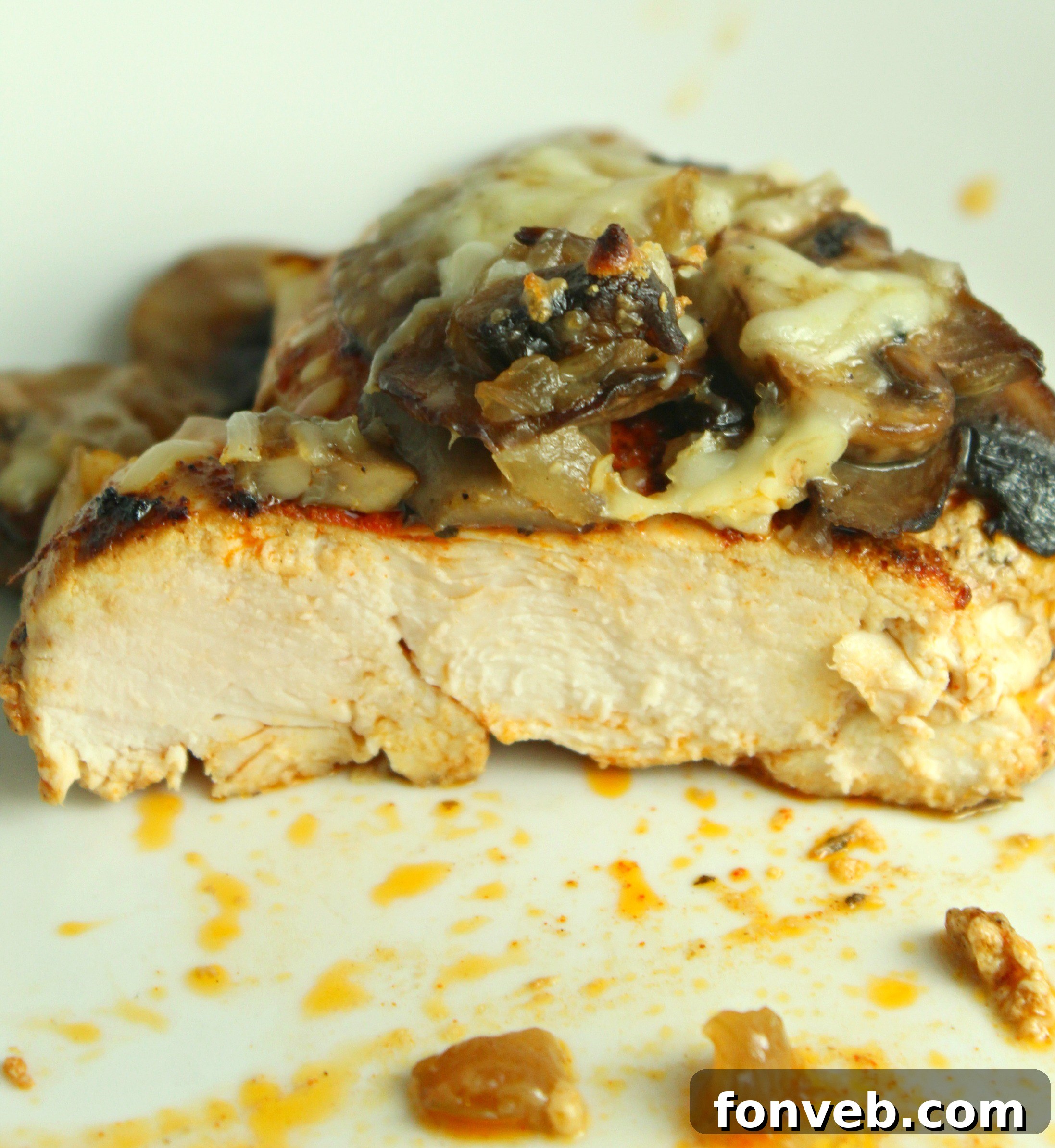 Creamy Cheesy Mushroom Chicken Keto Bake 9 A full view of the Smothered Cheesy Baked Chicken with Mushrooms, sliced and ready to be served, revealing juicy chicken.