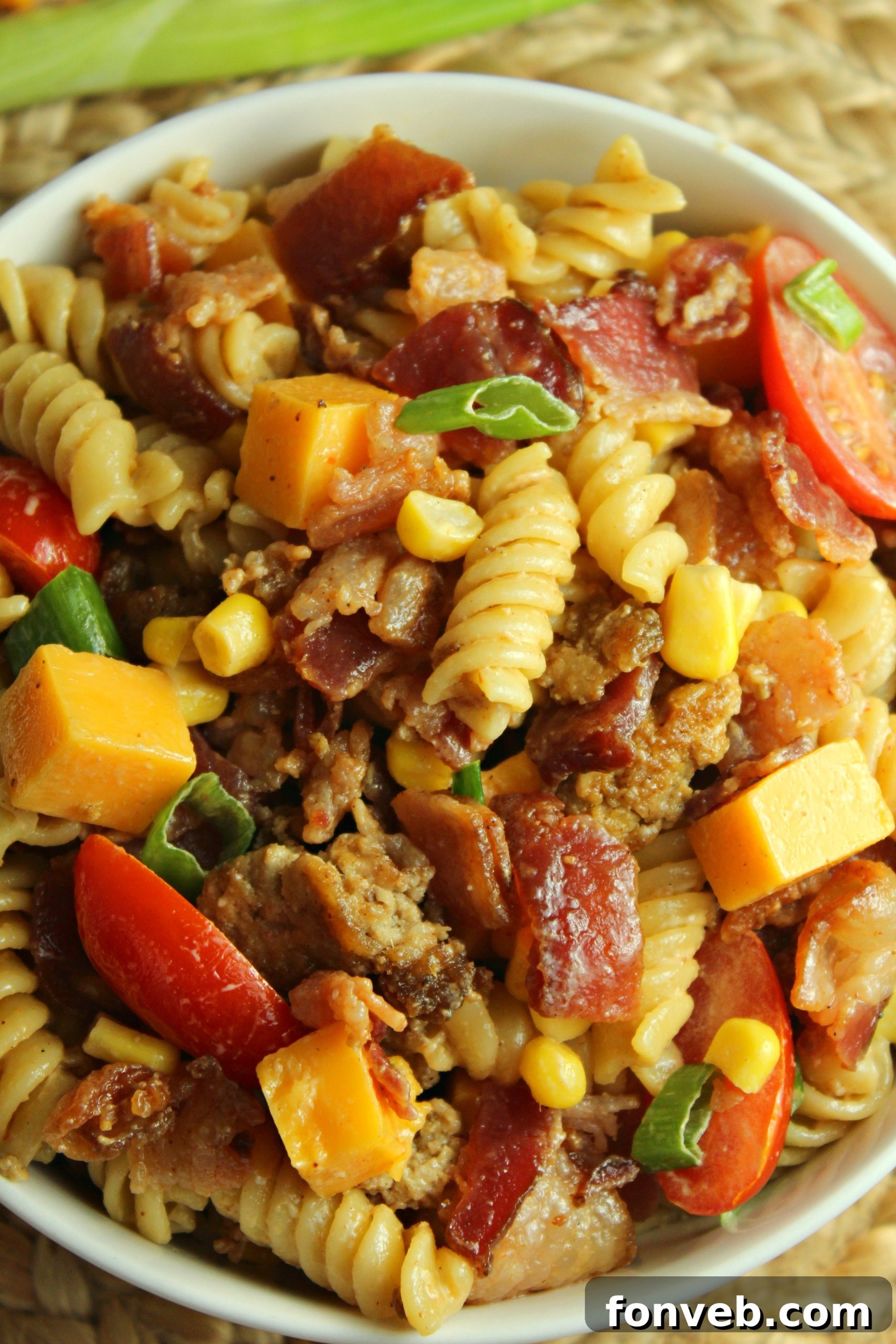 Close-up of creamy Loaded Cowboy Pasta Salad with ingredients