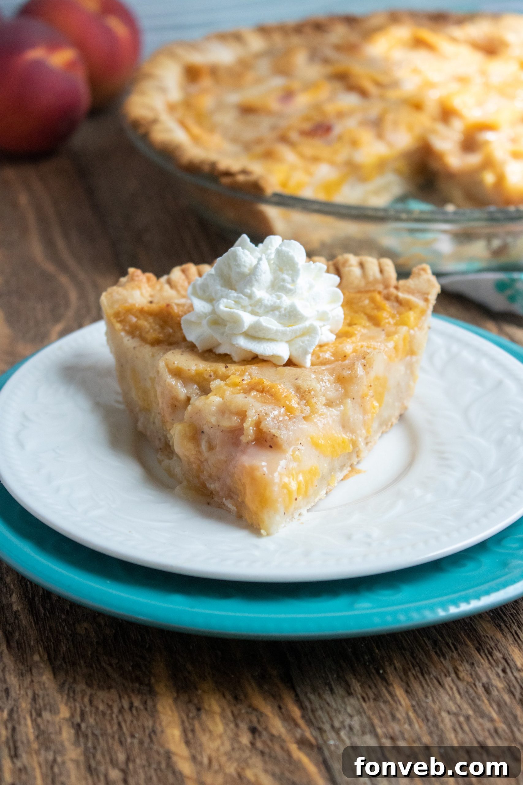 A beautifully baked Southern Peach Pie, golden brown and glistening with a hint of cinnamon on top.