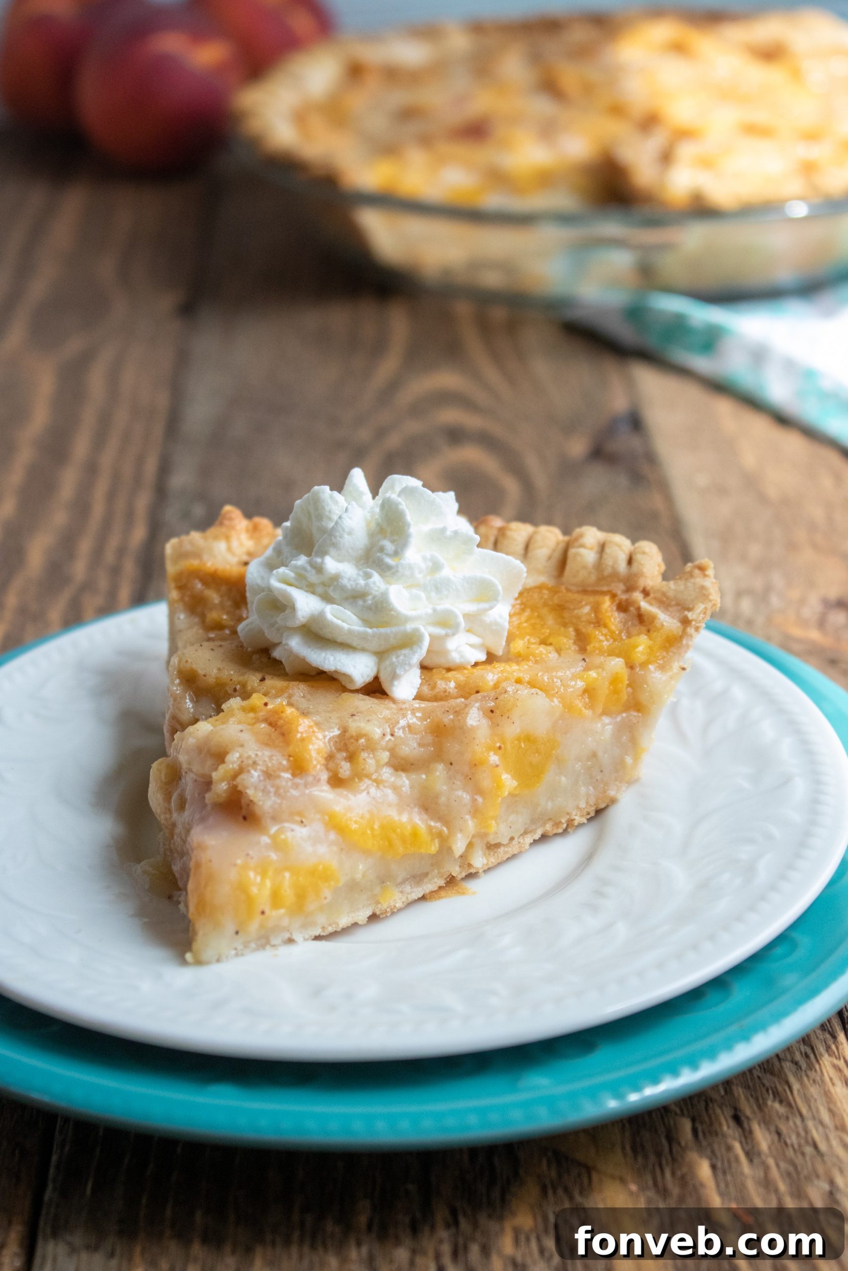 The baker's hands gently arranging freshly sliced peaches in an unbaked pie crust, showcasing the care involved.