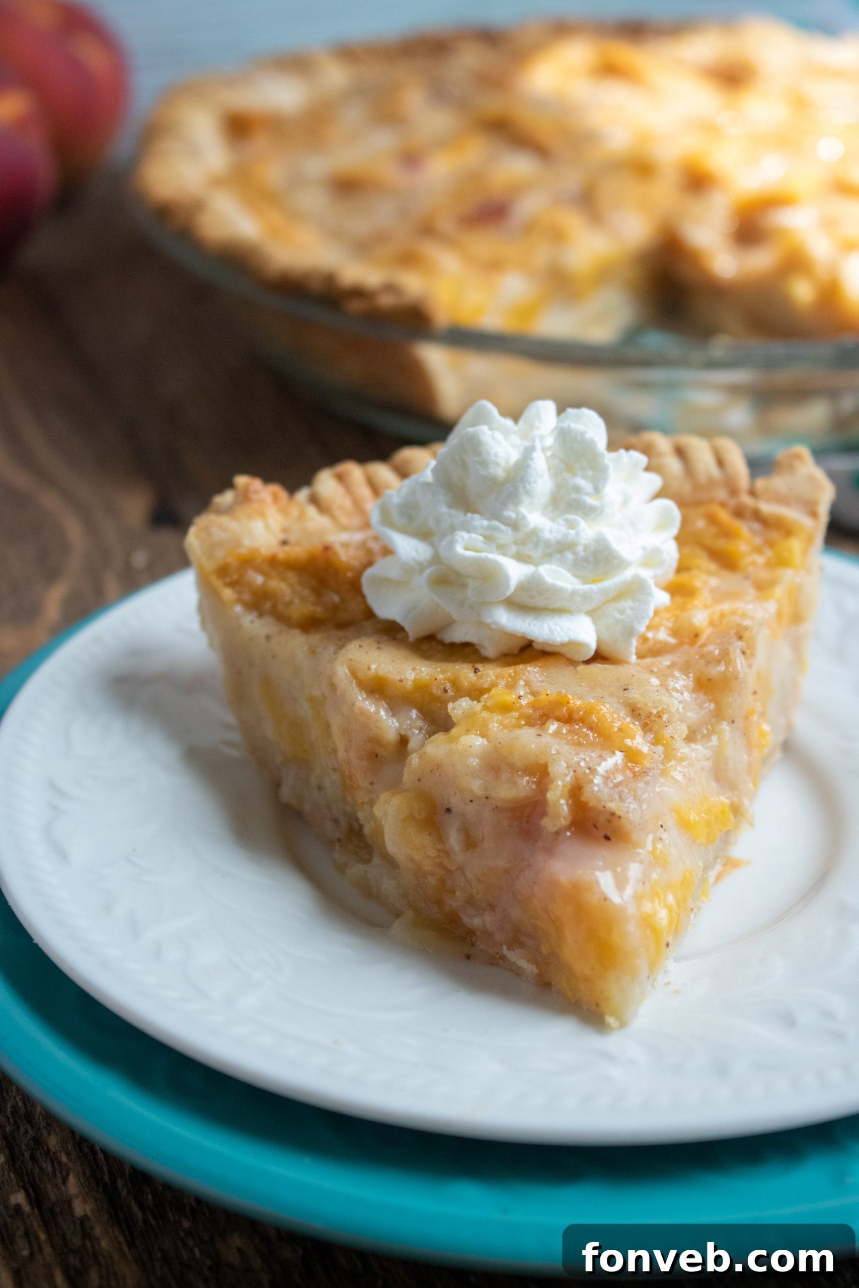 A perfectly baked, golden-brown peach pie with a beautifully crimped crust, cooling on a wire rack.