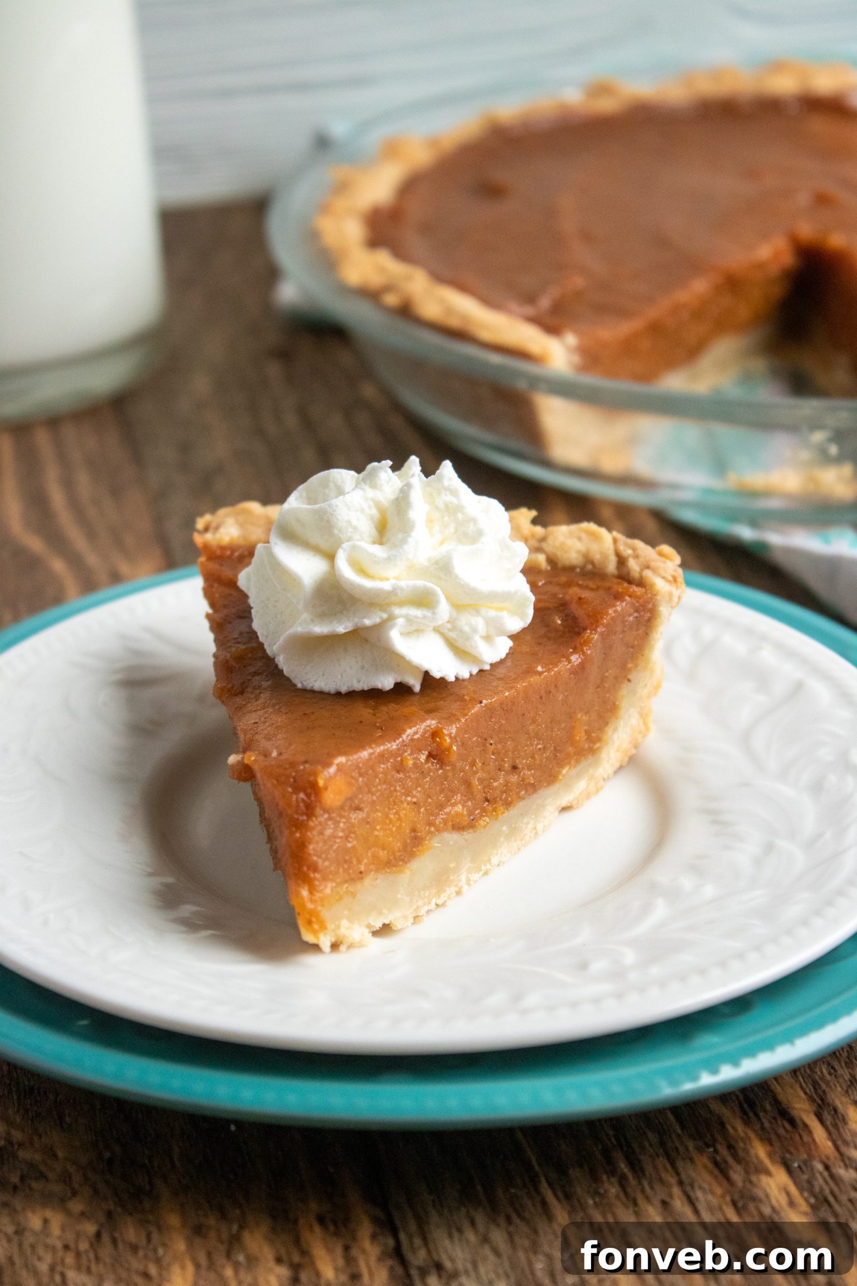 Close-up of a whole sweet potato pie, showcasing its perfect golden-brown crust