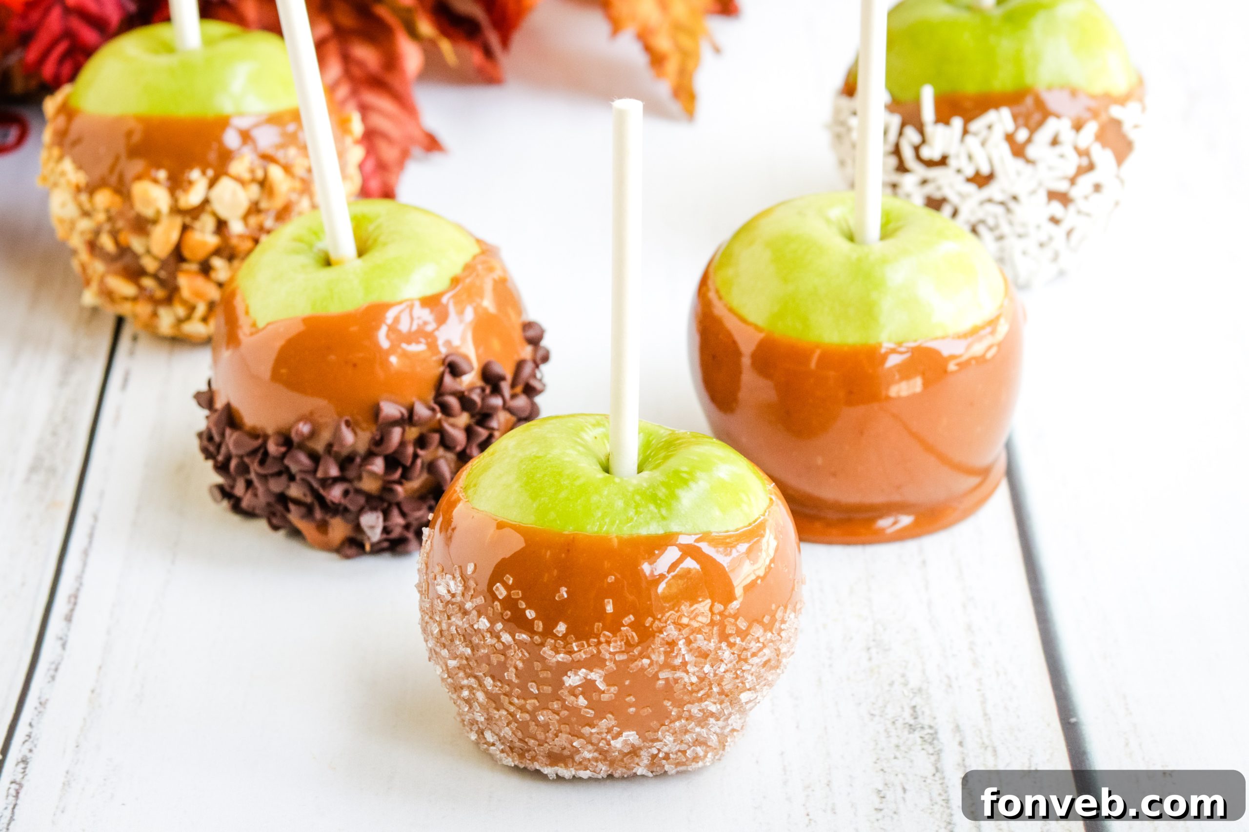 Delicious homemade caramel apples cooling on a rack.