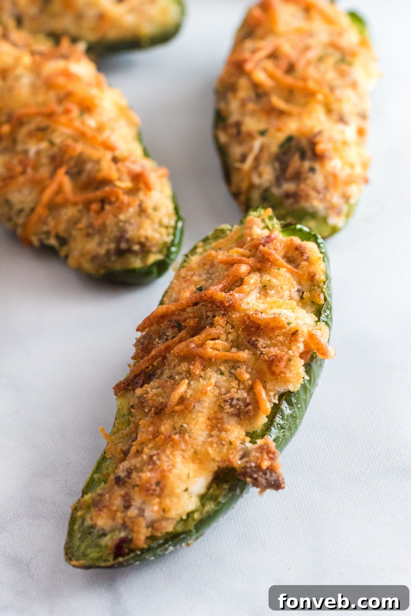 Basket of air fryer jalapeno poppers with a fork