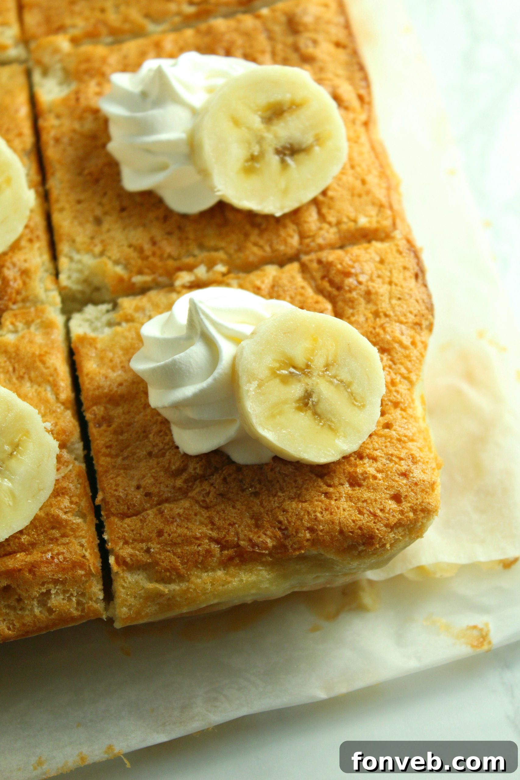 Banana Alchemy Cake 5 A large slice of Banana Magic Cake with a fork, emphasizing its ready-to-eat appeal.