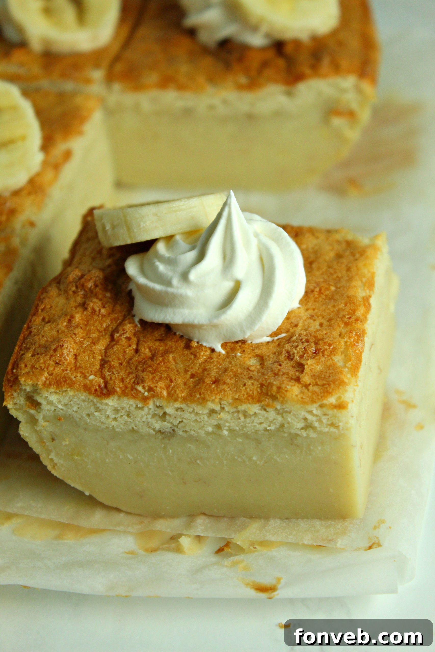 Banana Alchemy Cake 10 Two generous slices of Banana Magic Cake on parchment paper, ready to be enjoyed.