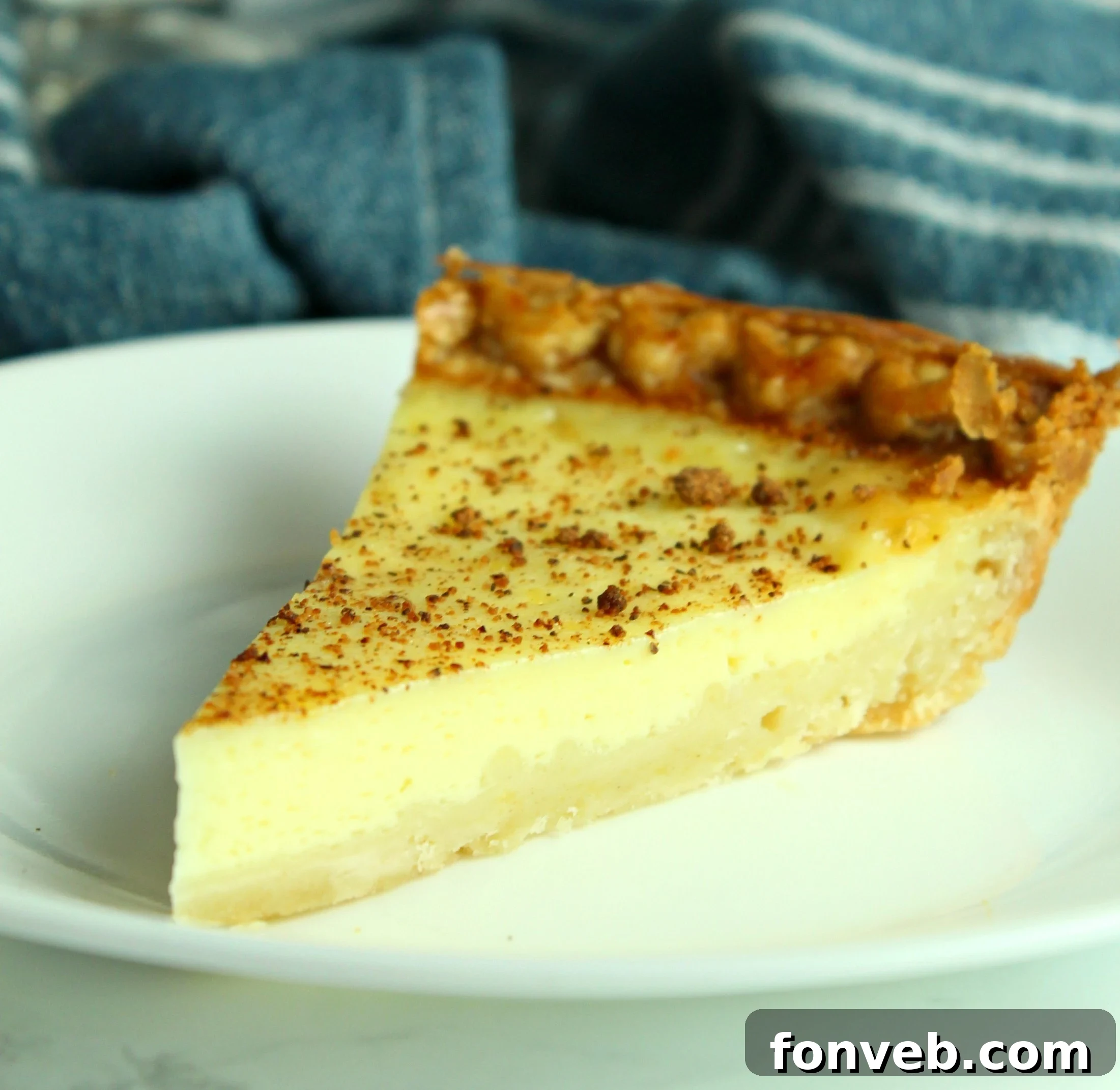 A close-up of the smooth, golden custard filling of the pie, showcasing its inviting texture.