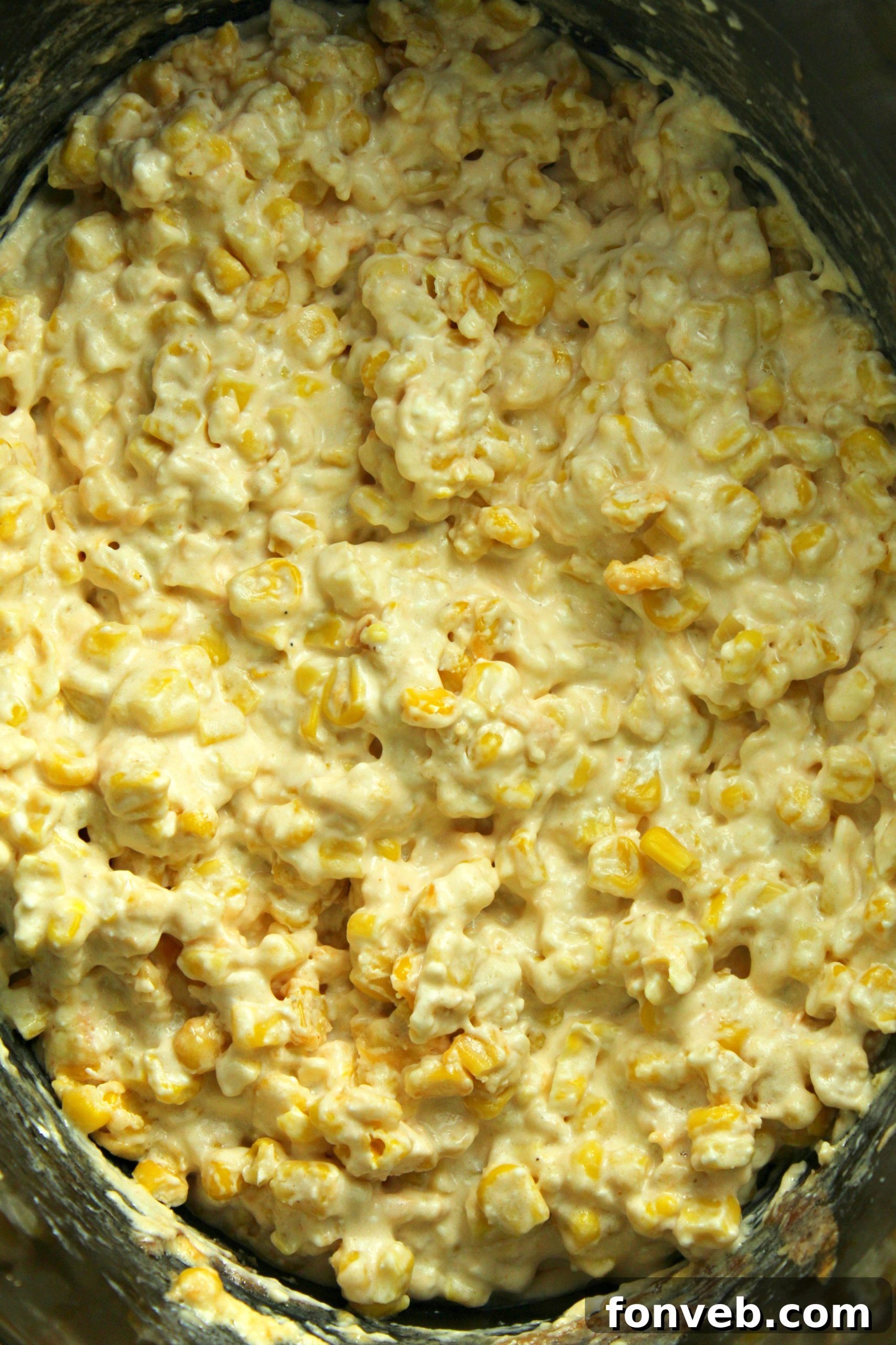 Another view of the creamy slow cooker cheesy corn in a serving dish, ready for family dinner.