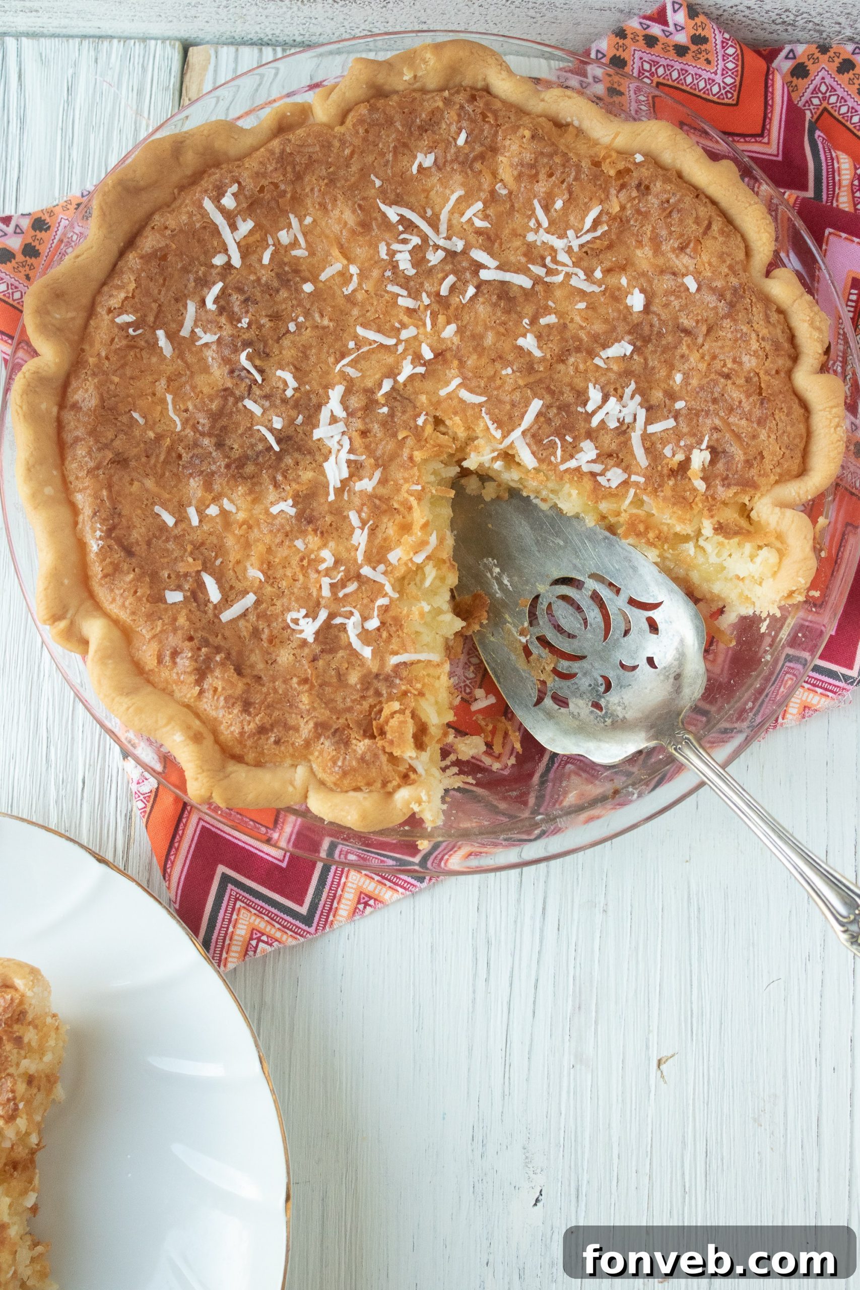 Nana's Classic Coconut Pie 5 Nana's Coconut Pie topped with freshly made whipped cream and a sprinkle of toasted coconut.
