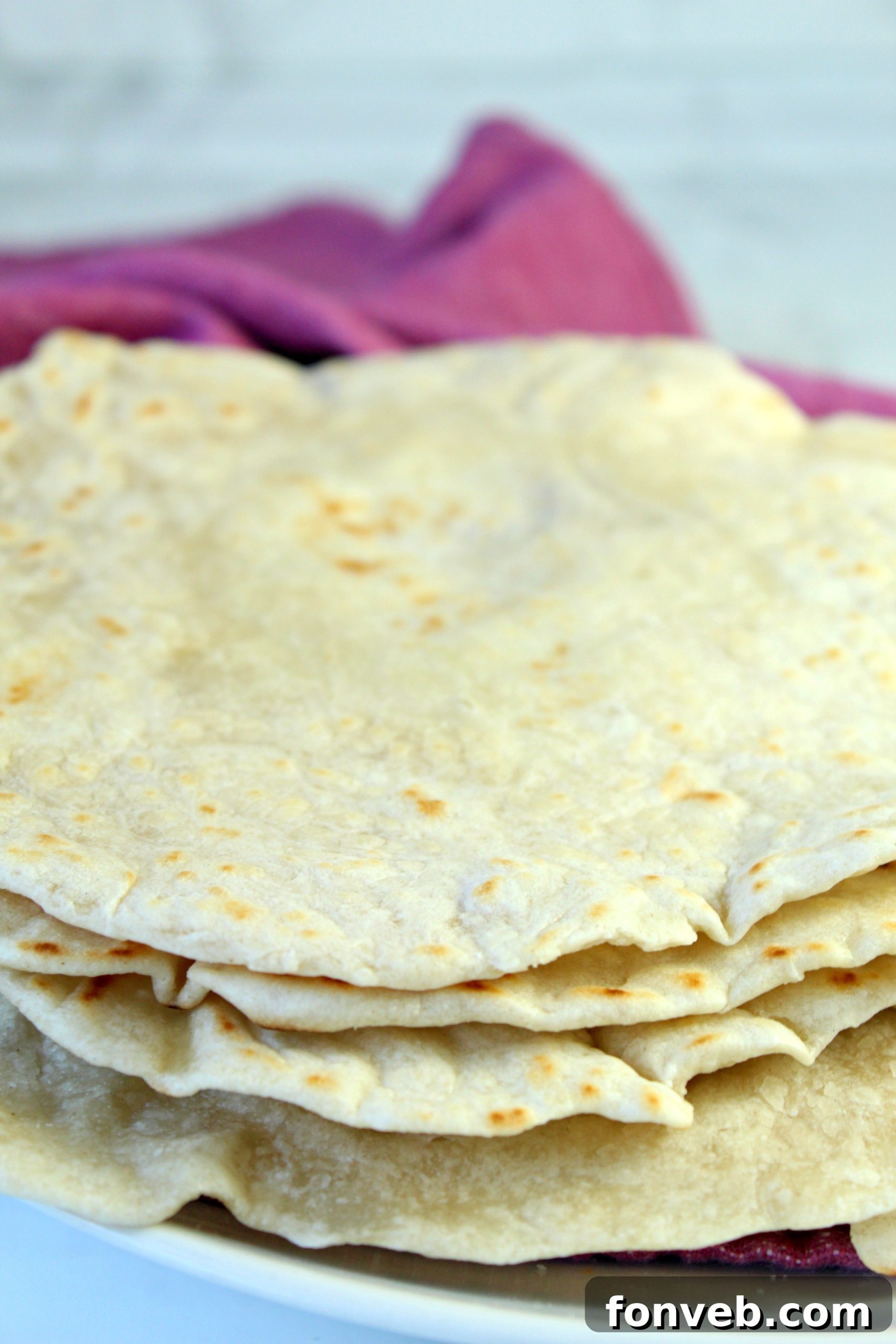 A cook rolling out tortilla dough