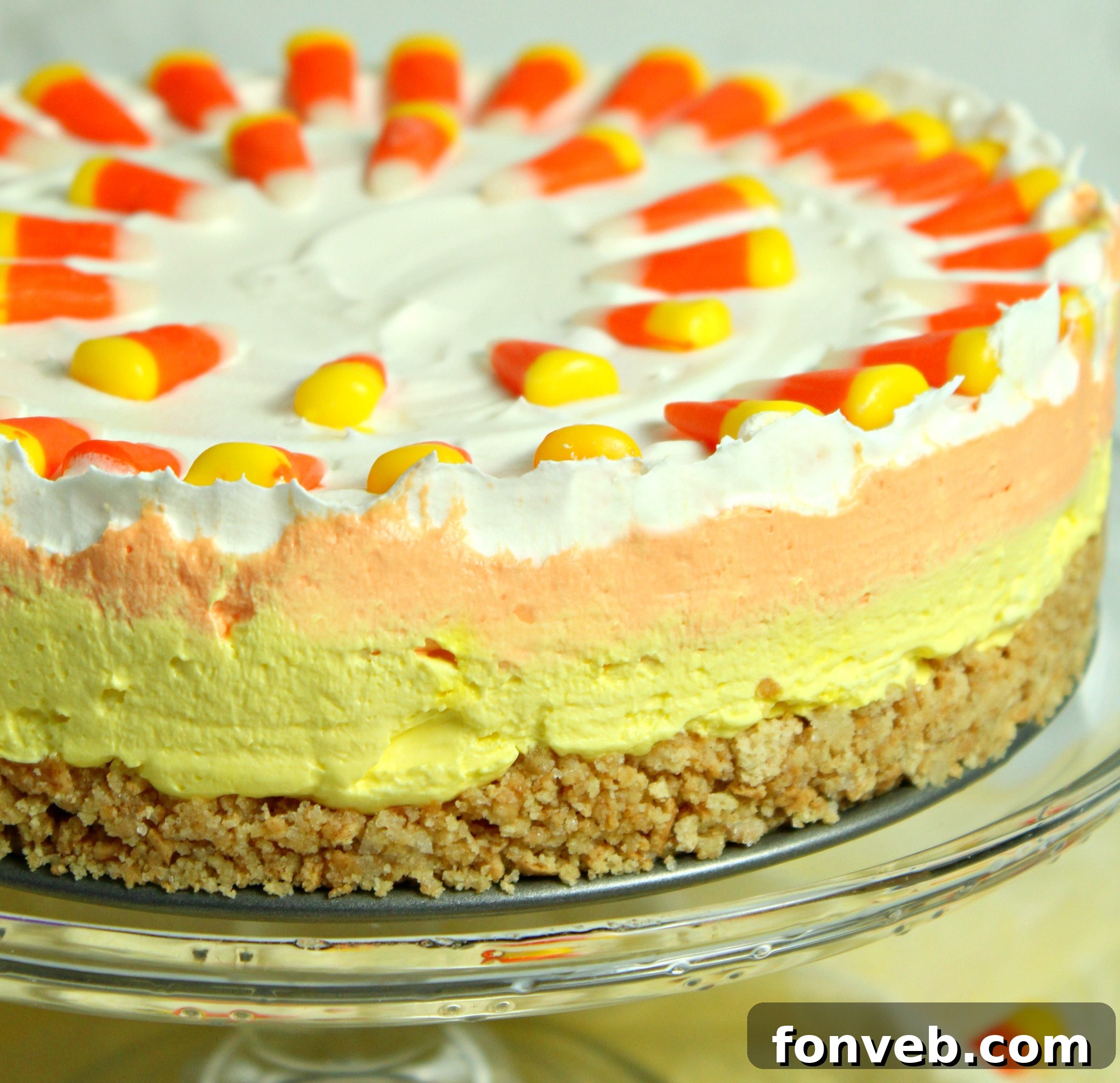 Effortless Autumn Candy Corn Cheesecake 4 A delicious slice of No Bake Candy Corn Cheesecake, garnished with candy corn.