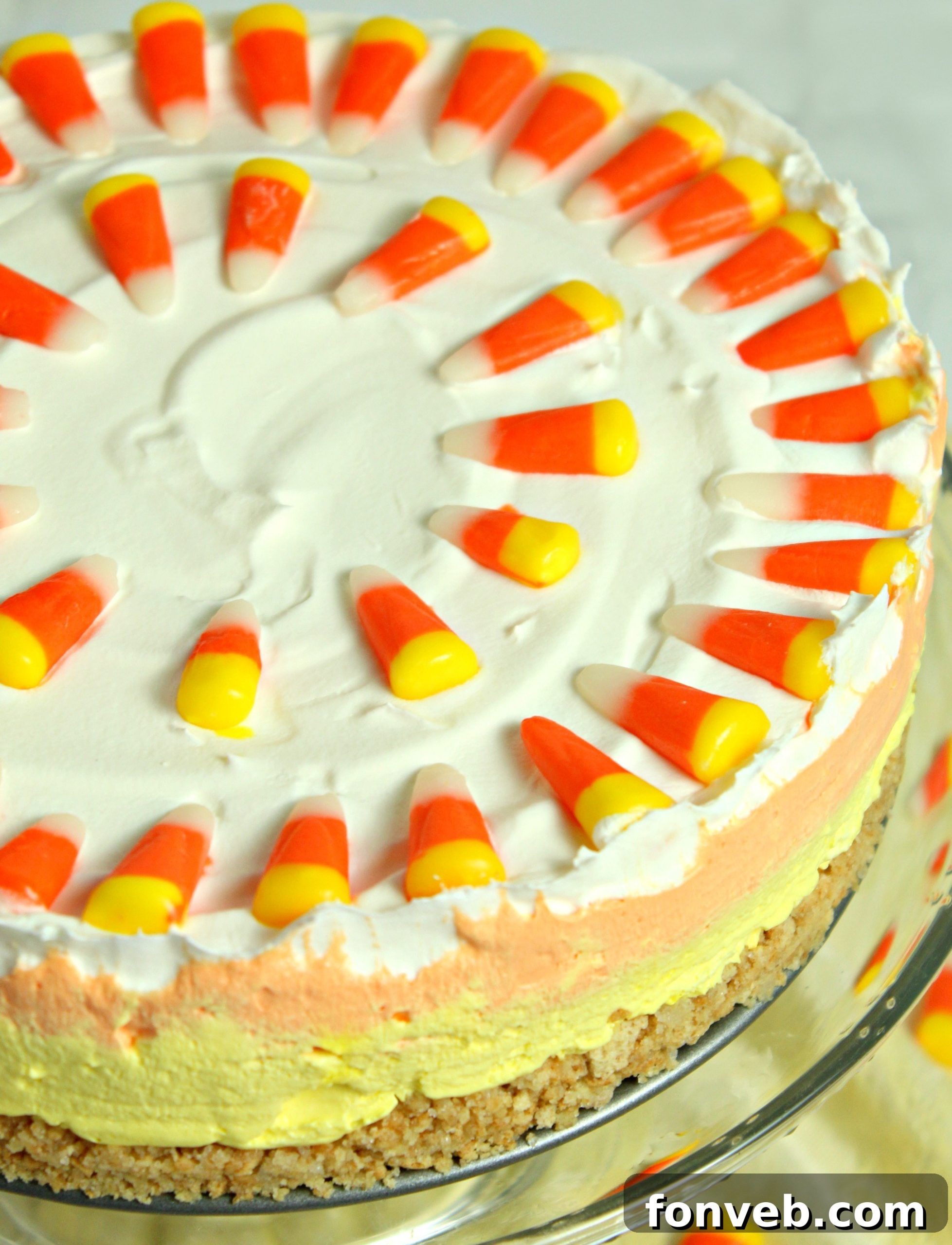 Effortless Autumn Candy Corn Cheesecake 7 Overhead view of a whole No Bake Candy Corn Cheesecake with festive decorations.