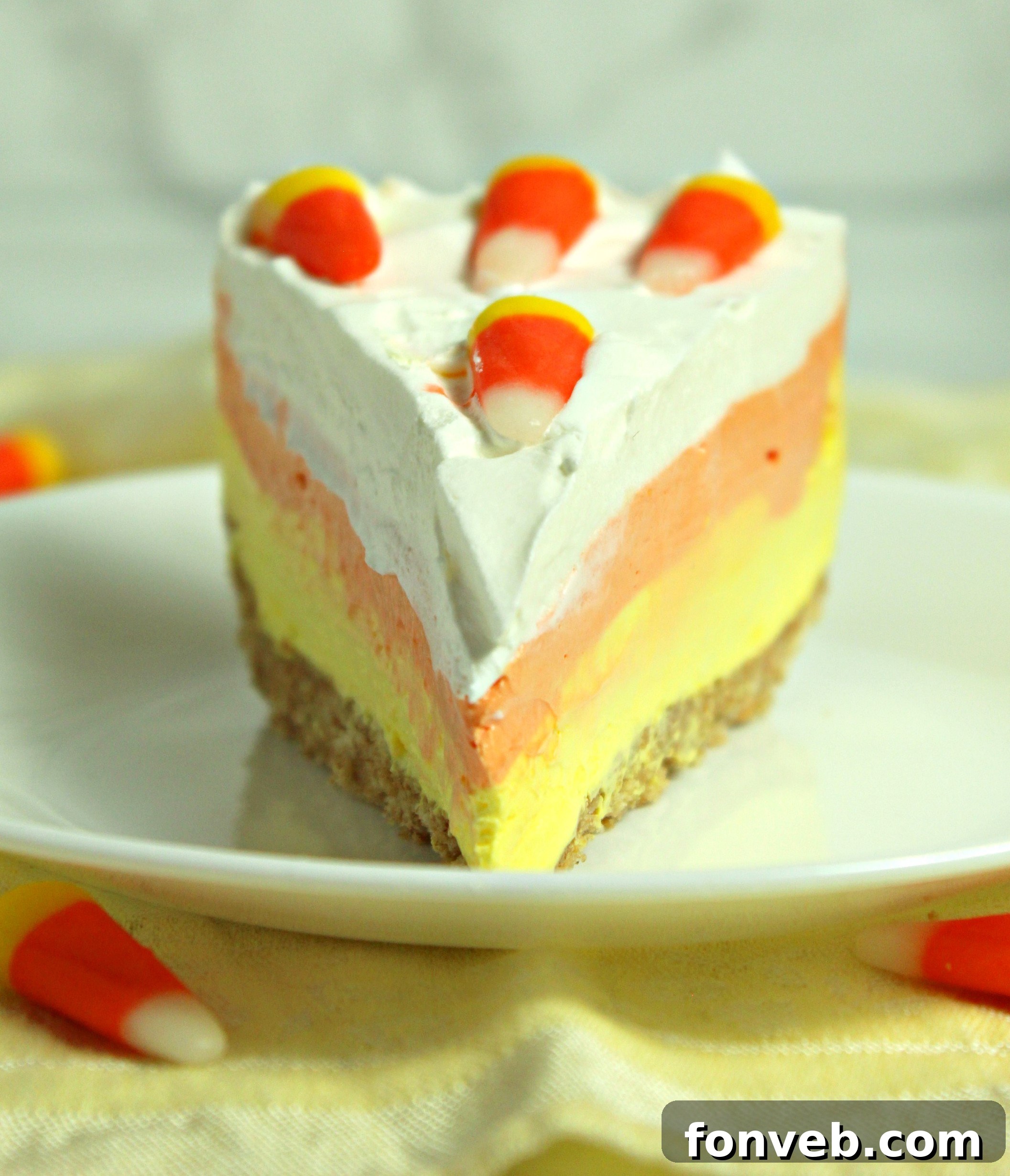 Effortless Autumn Candy Corn Cheesecake 8 More delicious slices of No Bake Candy Corn Cheesecake, ready to be enjoyed.