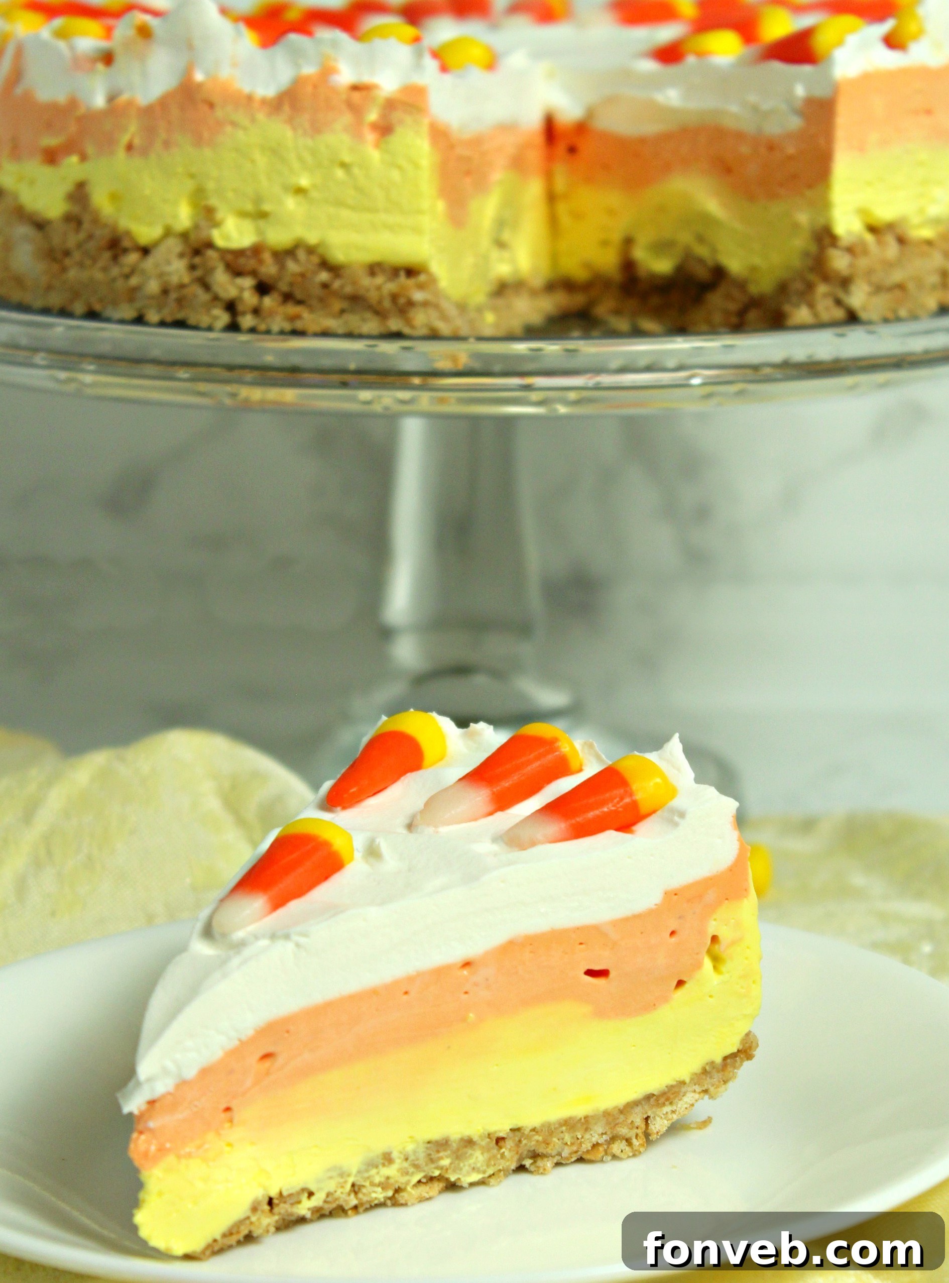 Effortless Autumn Candy Corn Cheesecake 9 Final plated slice of No Bake Candy Corn Cheesecake, topped with candy corn.