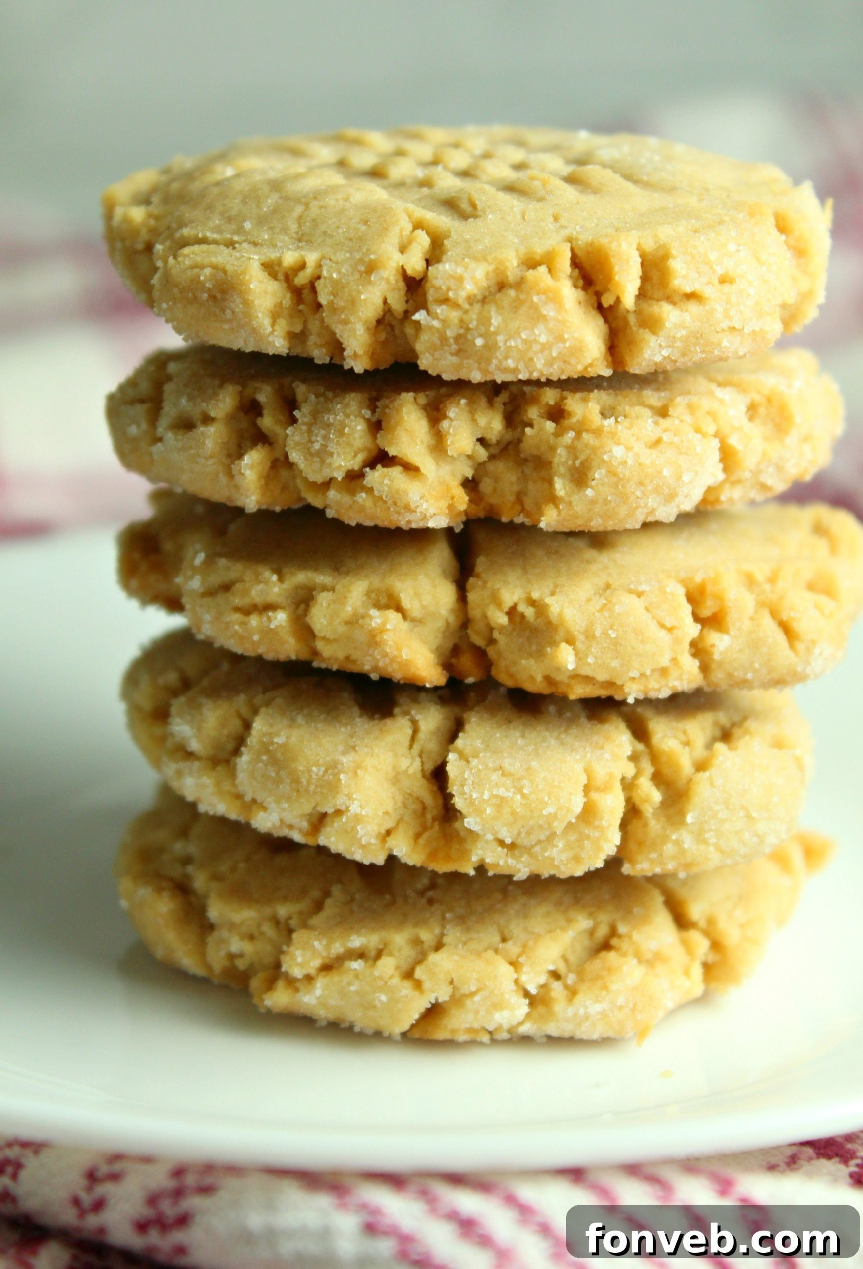 A stack of golden brown peanut butter cookies with their signature criss-cross pattern.